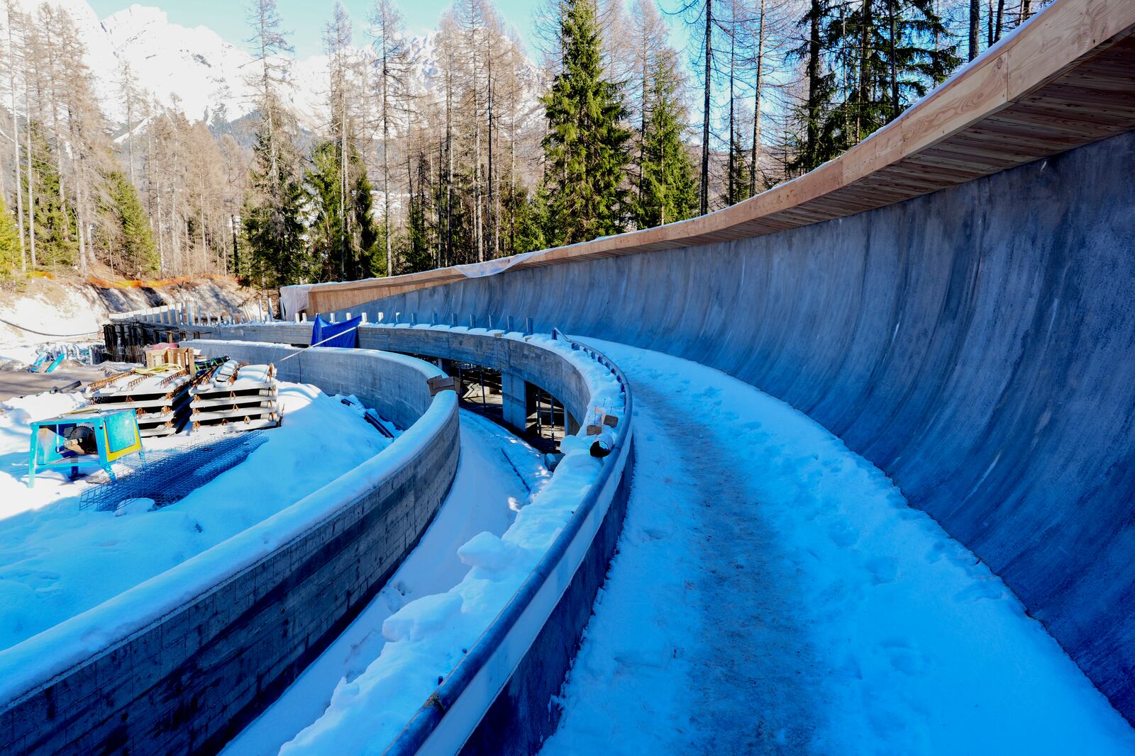 Construction work takes place at the Cortina Sliding Center, venue for the bob, luge and skeleton disciplines at the Milan Cortina 2026 Winter Olympics, in Cortina d'Ampezzo, Italy, Thursday, Jan. 16, 2025. (AP Photo/Giovanni Auletta)