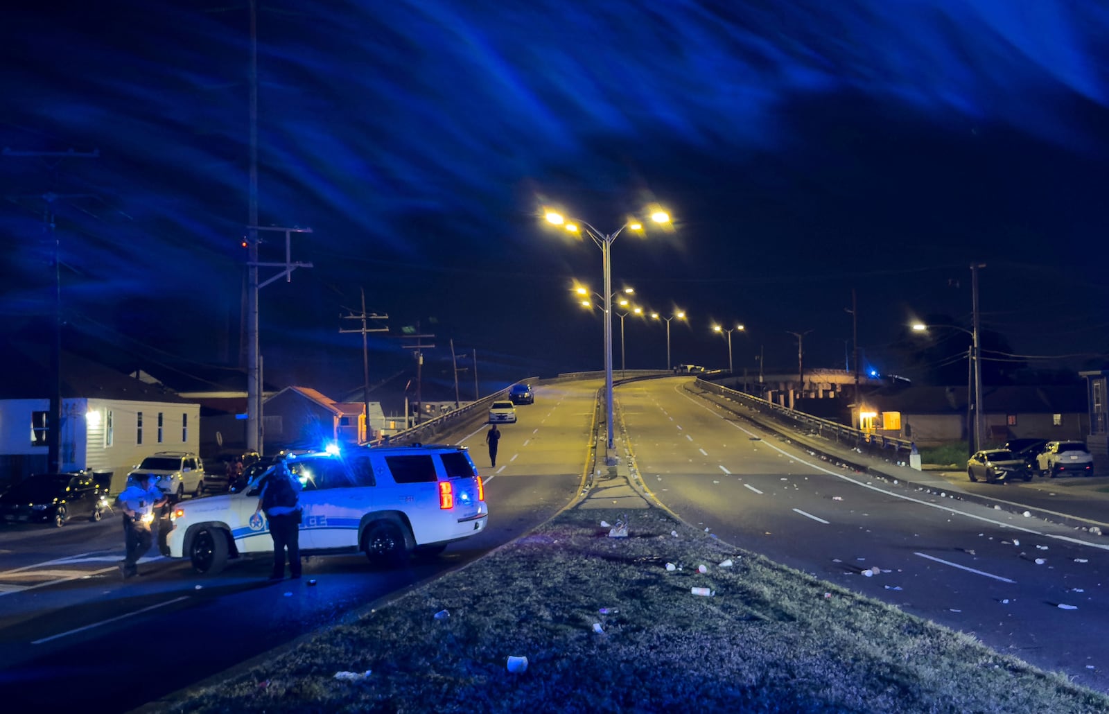 New Orleans Police block the Almonaster Avenue Bridge after a deadly shooting during a second line celebration in New Orleans, Sunday Nov. 17, 2024. (David Grunfeld/The Times-Picayune/The New Orleans Advocate via AP)