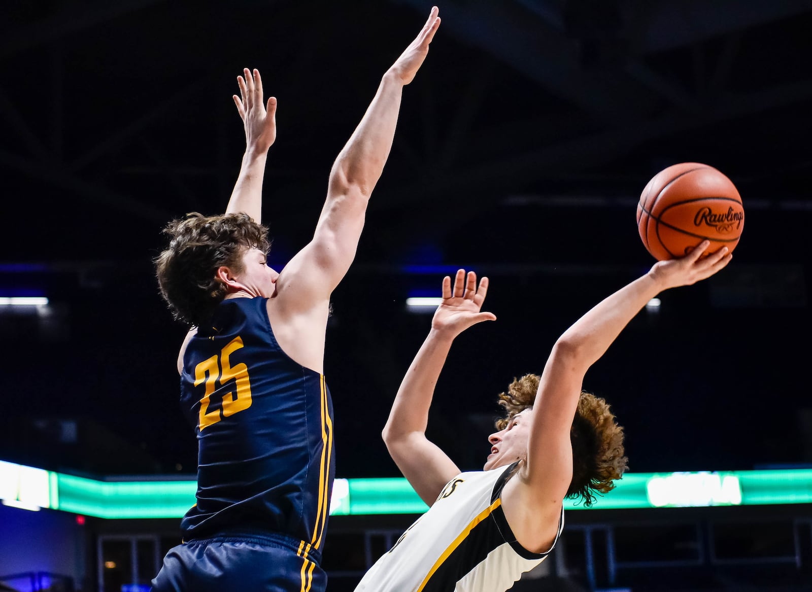 Centerville's Drew Thompson puts up a shot defended by Archbishop Moeller's Michael Currin March 11, 2020 in their Division I Regional boys basketball semifinal at Xavier University's Cintas Center. NICK GRAHAM / STAFF