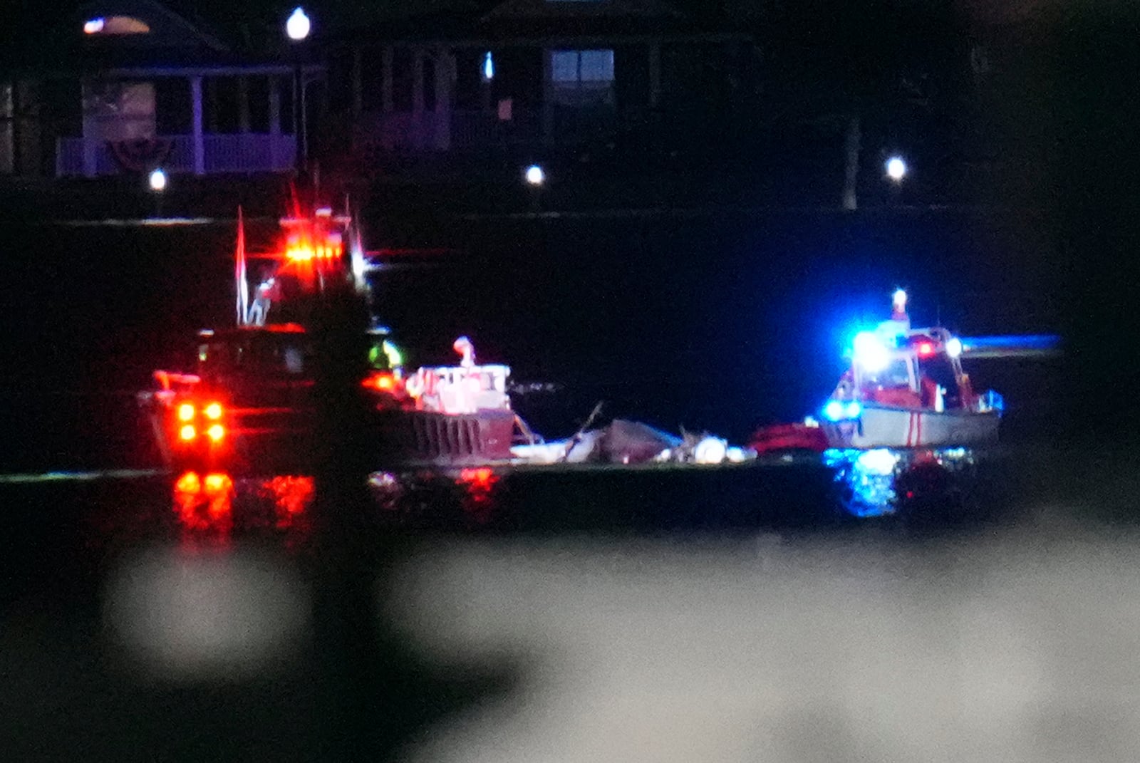 Boats work the scene on the Potomac River near Ronald Reagan Washington National Airport, Wednesday, Jan. 29, 2025, in Arlington, Va. (AP Photo/Julio Cortez)