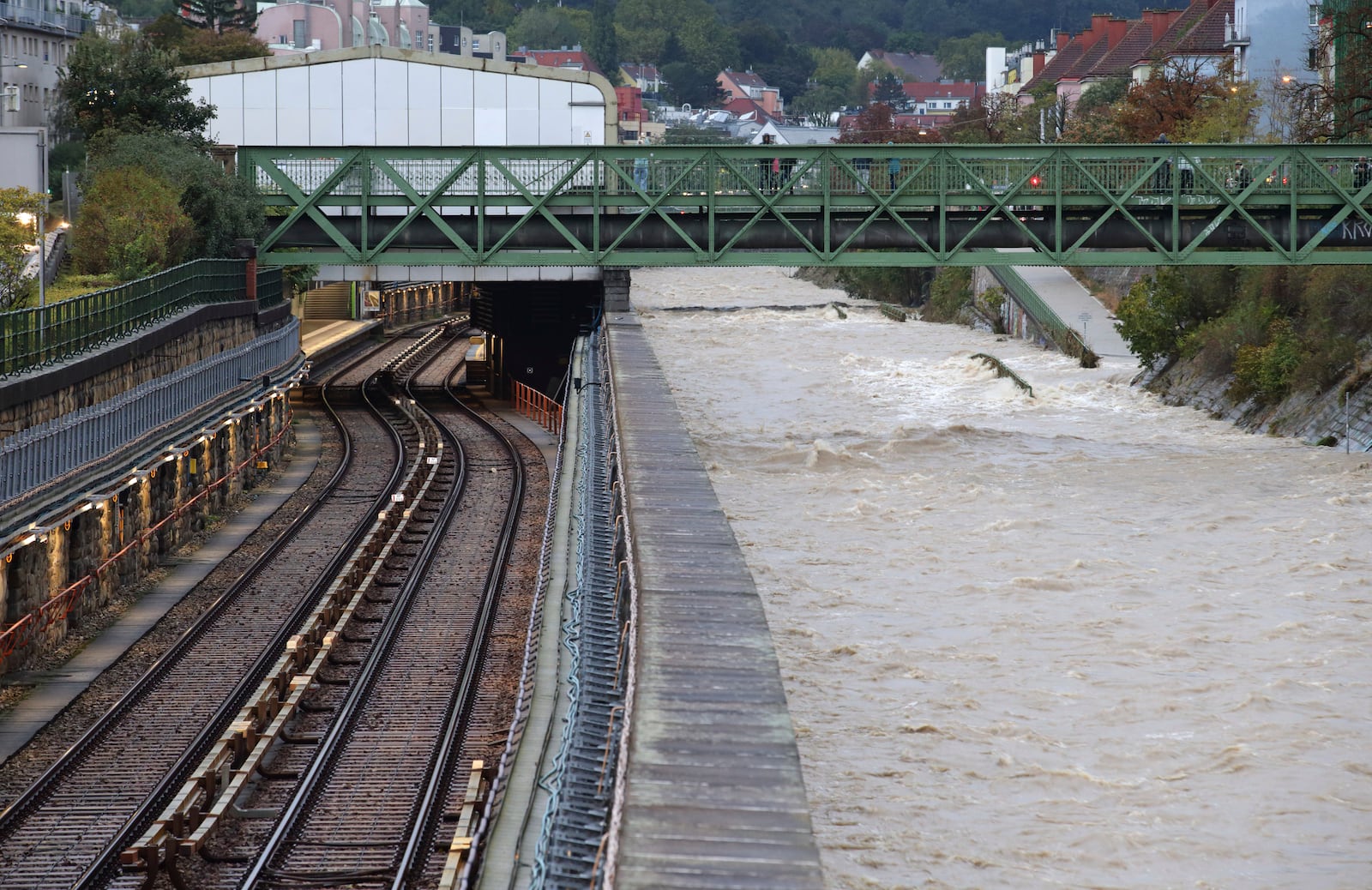 River Wien floods its banks next to tracks and a closed subway station in the west of Vienna, Austria, Sunday, Sept. 15, 2024. (AP Photo/Heinz-Peter Bader)