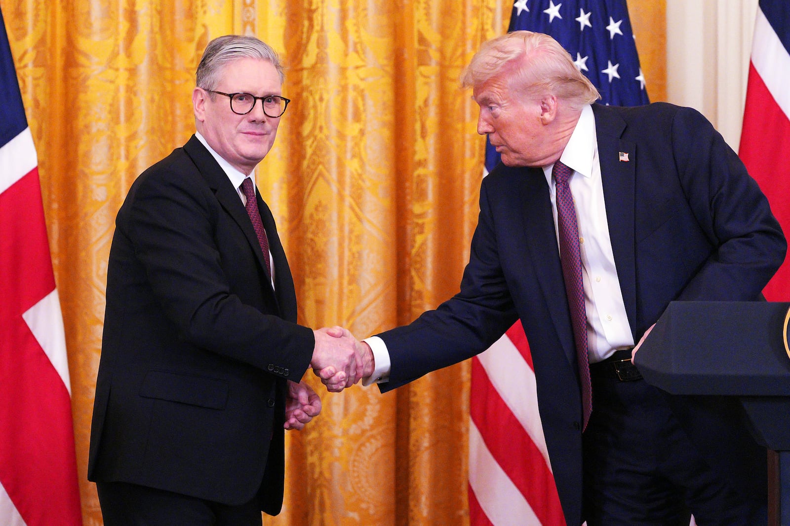 Britain's Prime Minister Keir Starmer, left, and U.S. President Donald Trump shake hands at a joint press conference in the East Room at the White House Thursday, Feb. 27, 2025, in Washington. (Carl Court/Pool Photo via AP)