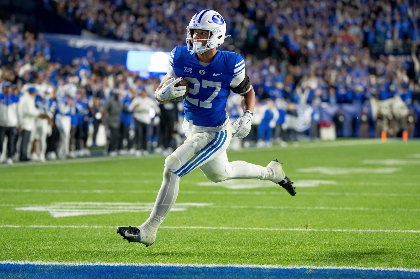 BYU running back LJ Martin runs in for a touchdown in the second half of an NCAA college football game against Oklahoma State, Friday, Oct. 18, 2024, in Provo, Utah. (AP Photo/Spenser Heaps)