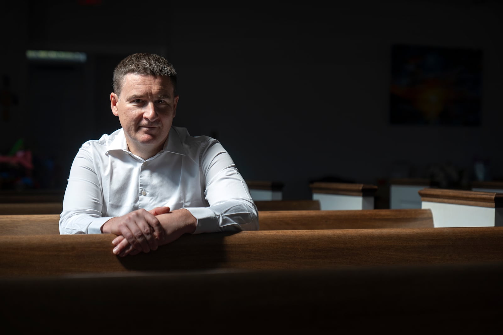 Slavik Pyzh, the president of the Ukrainian Baptist Theological Seminary in Lviv, Ukraine, sits in the sanctuary of a Baptist church in Arlington, Va., Tuesday, Sept. 3, 2024. (AP Photo/Mark Schiefelbein)