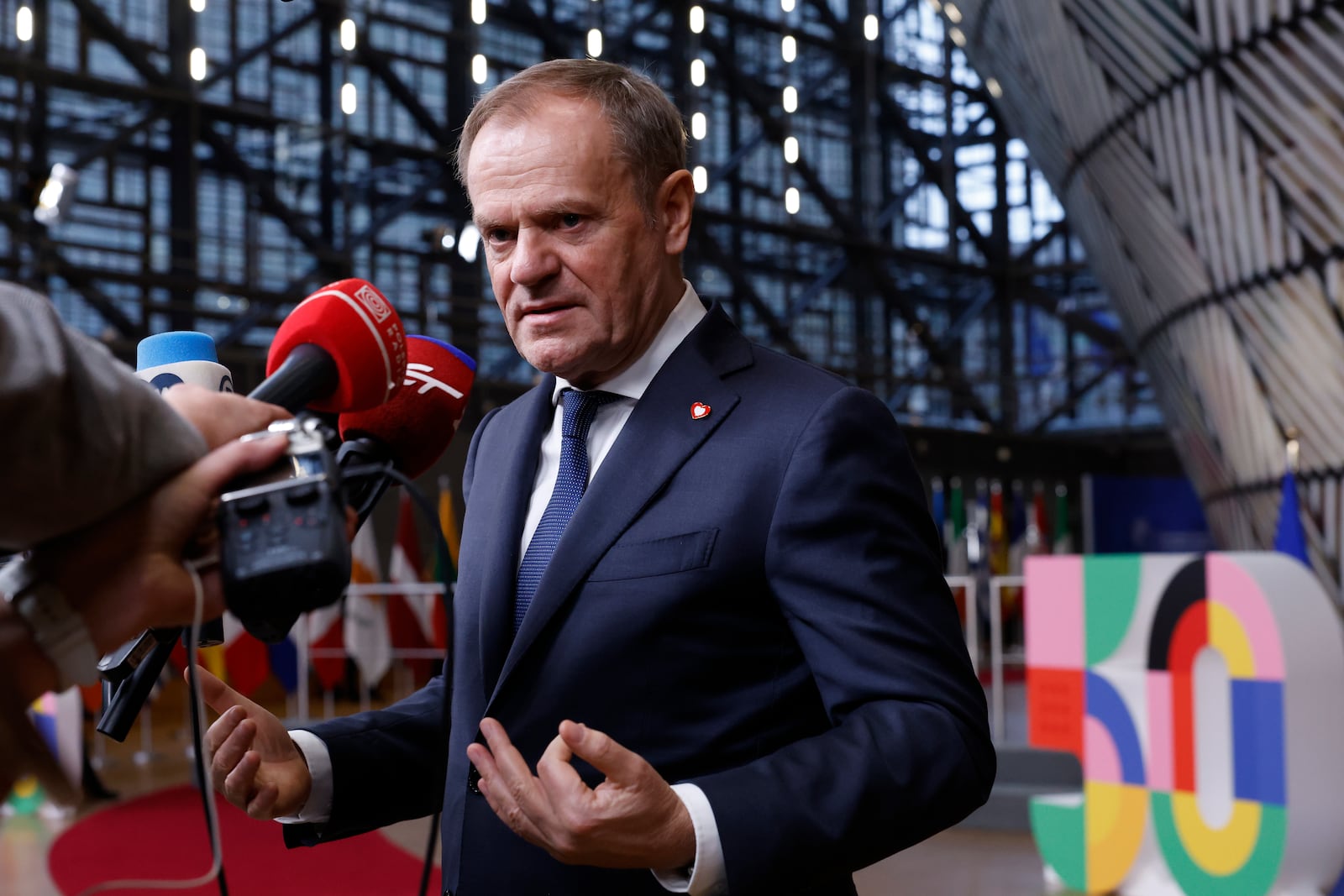 Poland's Prime Minister Donald Tusk speaks with the media prior to a group photo at an EU summit in Brussels, Thursday, Dec. 19, 2024. (AP Photo/Omar Havana)