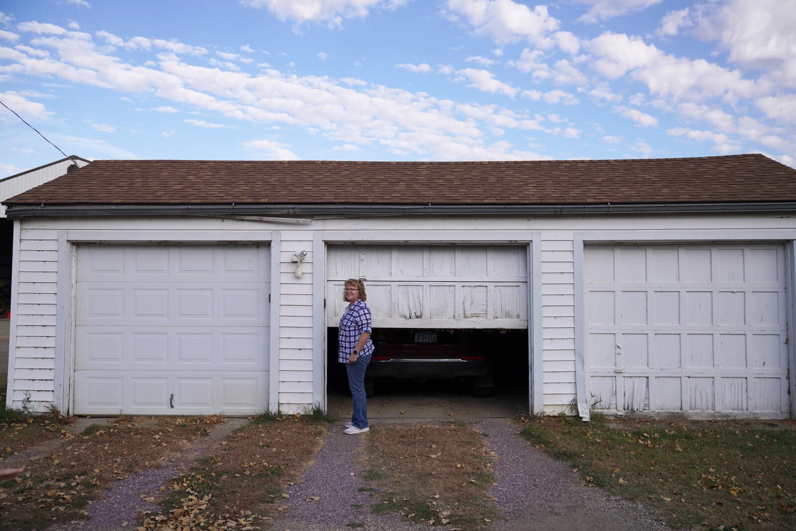 Julie Robinson opens her garage on property her family has owned for 132 years, in Worthington, Minn., on Monday, Oct. 21, 2024. (AP Photo/Jessie Wardarski)