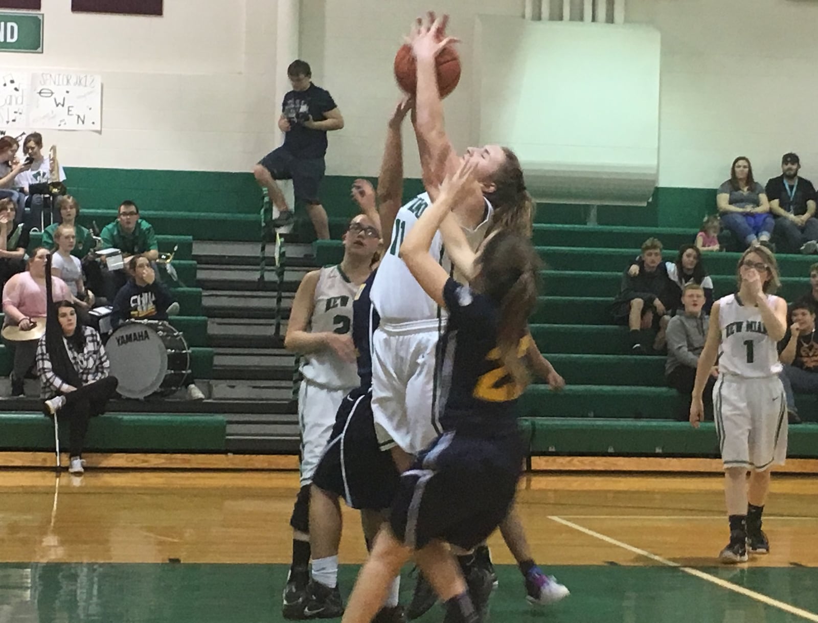 New Miami’s Kristyn Riley (11) goes up with the ball in a crowd during Wednesday night’s game against Lockland at New Miami. RICK CASSANO/STAFF