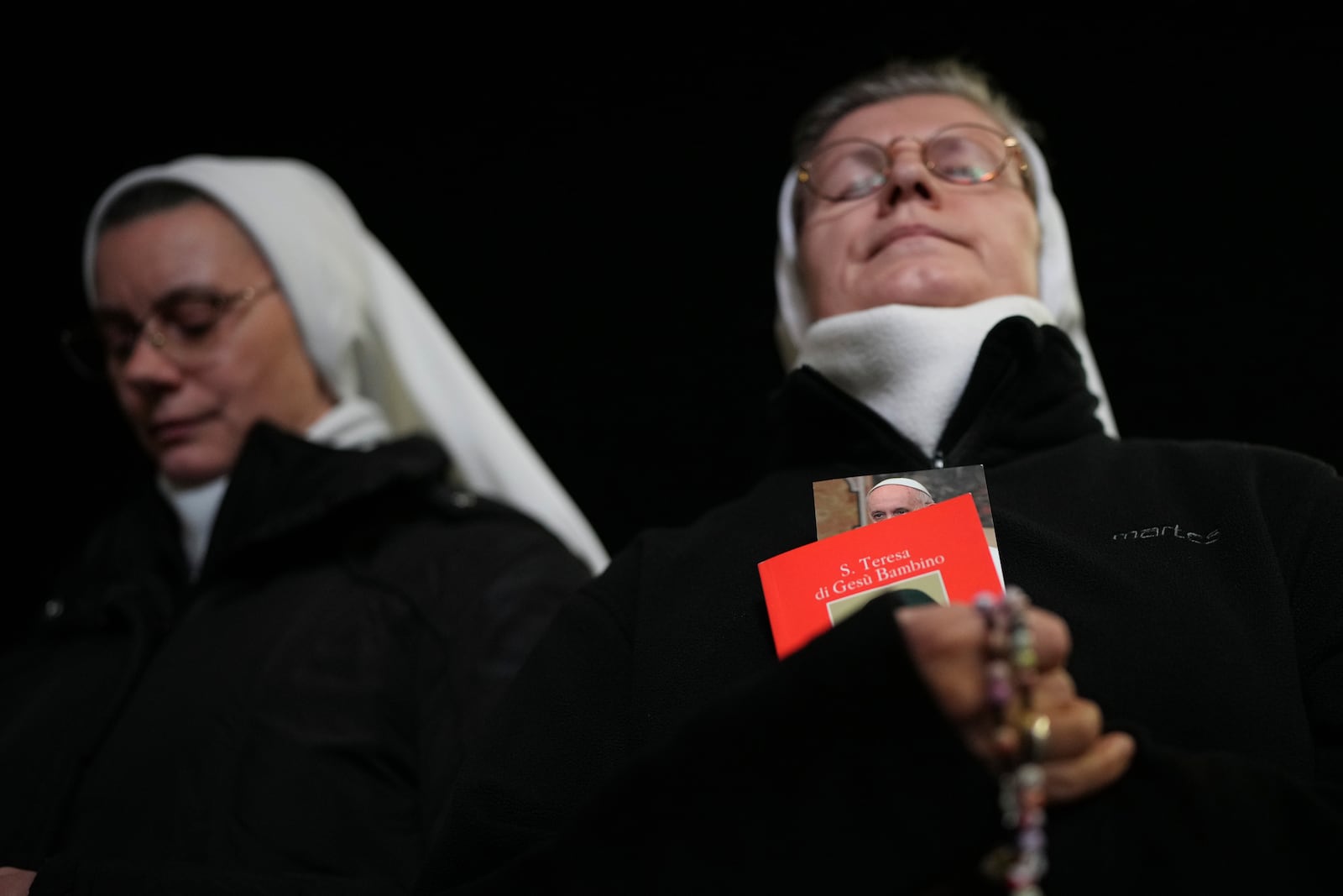 Nuns pray during a rosary prayer for Pope Francis' health in St. Peter's Square at the Vatican, Thursday, Feb. 27, 2025. (AP Photo/Alessandra Tarantino)