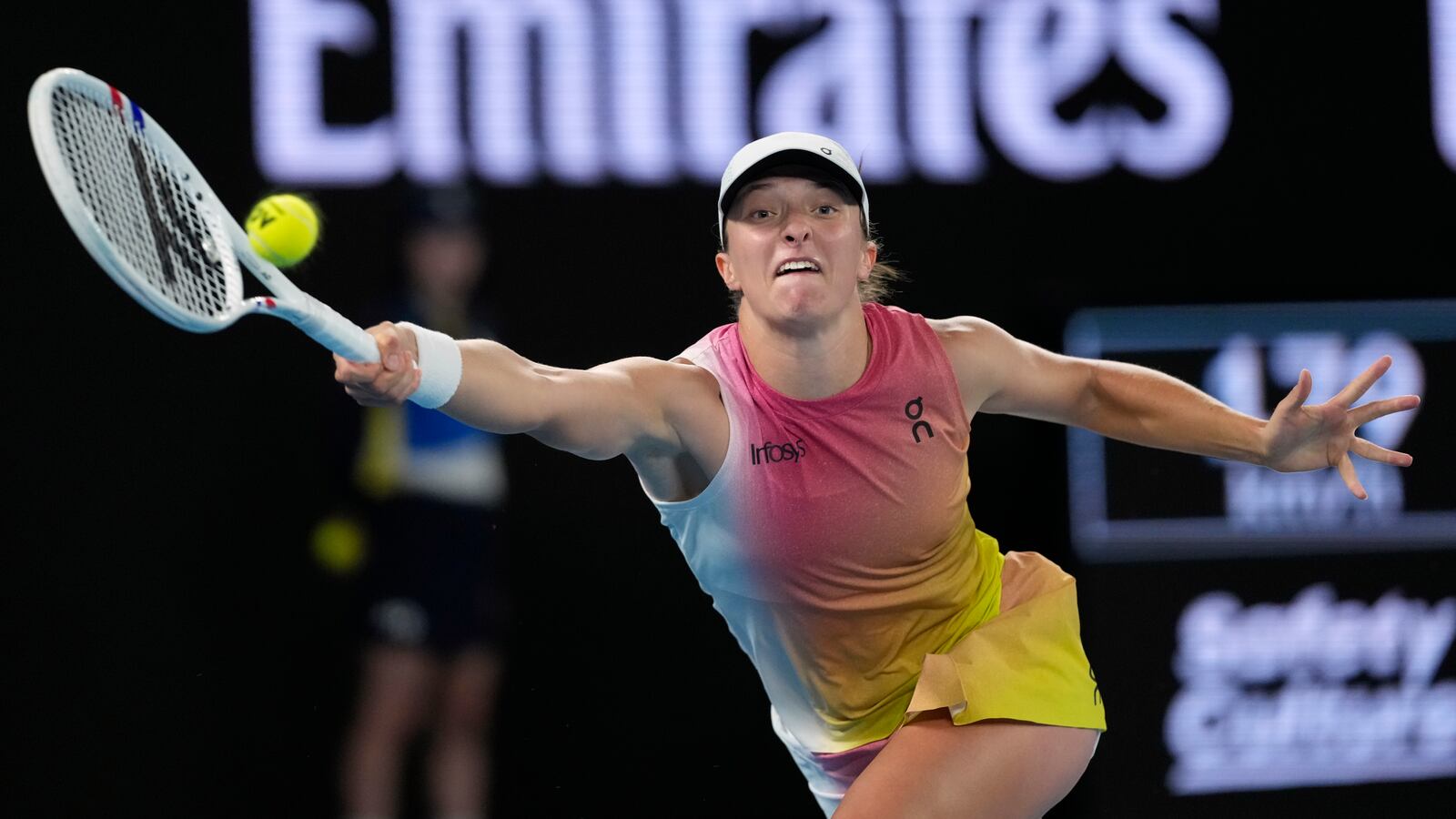 Iga Swiatek of Poland plays a forehand return to Madison Keys of the U.S. during their semifinal match at the Australian Open tennis championship in Melbourne, Australia, Thursday, Jan. 23, 2025. (AP Photo/Asanka Brendon Ratnayake)