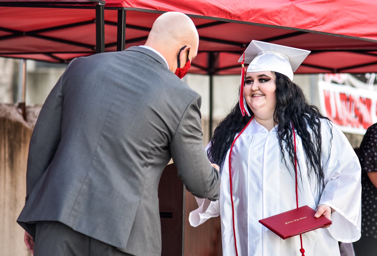 Madison High School drive-thru graduation ceremony at Land of Illusion