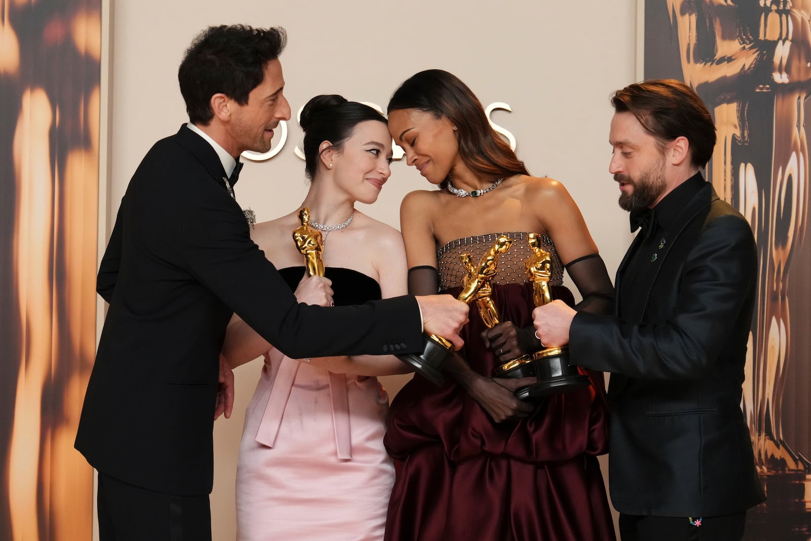 Adrien Brody, from left, winner of the award for best performance by an actor in a leading role for "The Brutalist," Mikey Madison, winner of the award for best performance by an actress in a leading role for "Anora," Zoe Saldana, winner of the award for best performance by an actress in a supporting role for "Emilia Perez," and Kieran Culkin, winner of the award for best performance by an actor in a supporting role for "A Real Pain," pose in the press room at the Oscars on Sunday, March 2, 2025, at the Dolby Theatre in Los Angeles. (Photo by Jordan Strauss/Invision/AP)