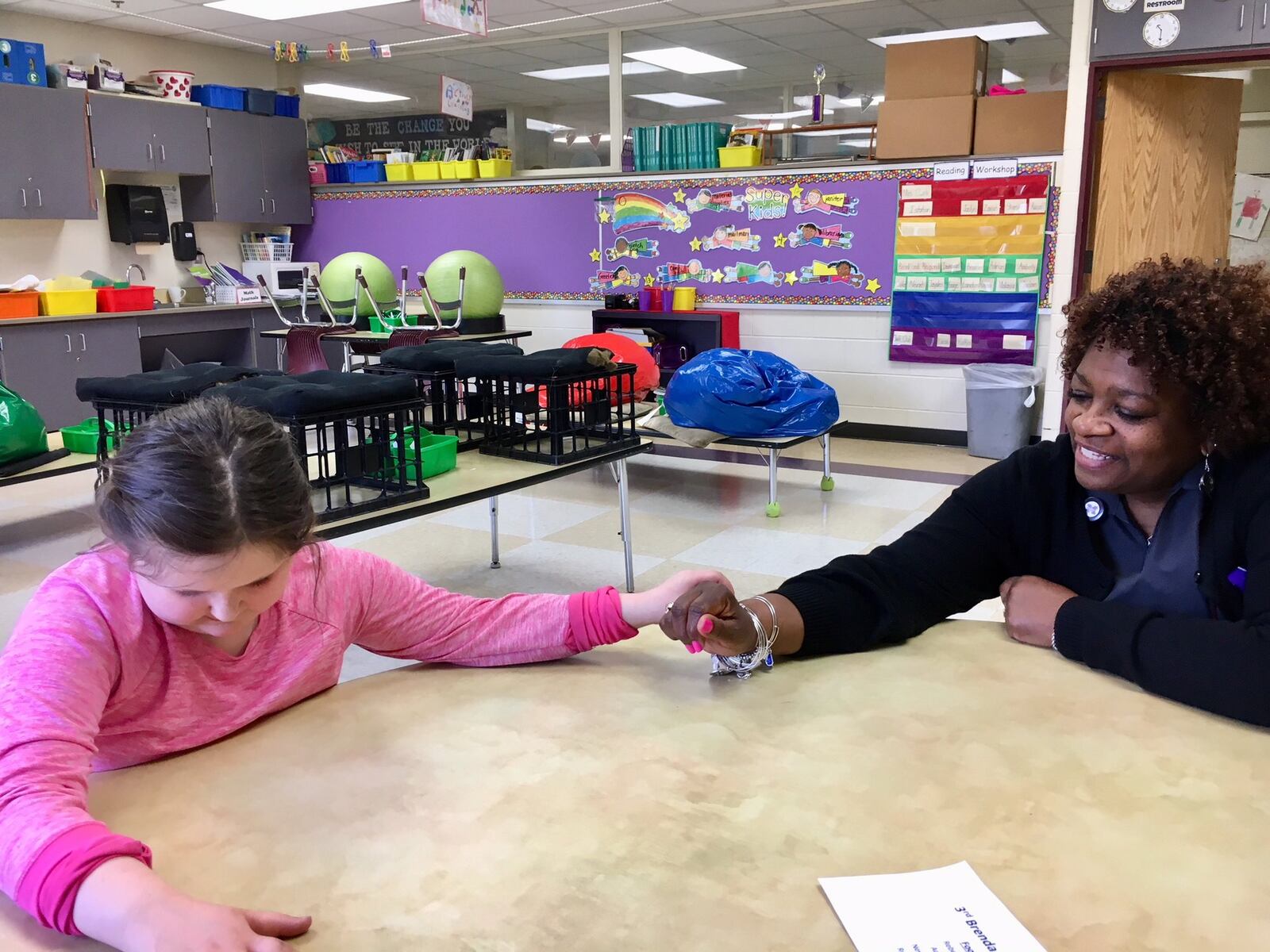 Despite being blind since birth, Middletown Amanda Elementary 3rd grader Breanah McNutt maneuvers around her school - and through her class work - with a determination fired by curiosity undeterred by her challenge. Here she examines with her hands the charm bracelet of Middletown central office staffer Gracie Gregory. 