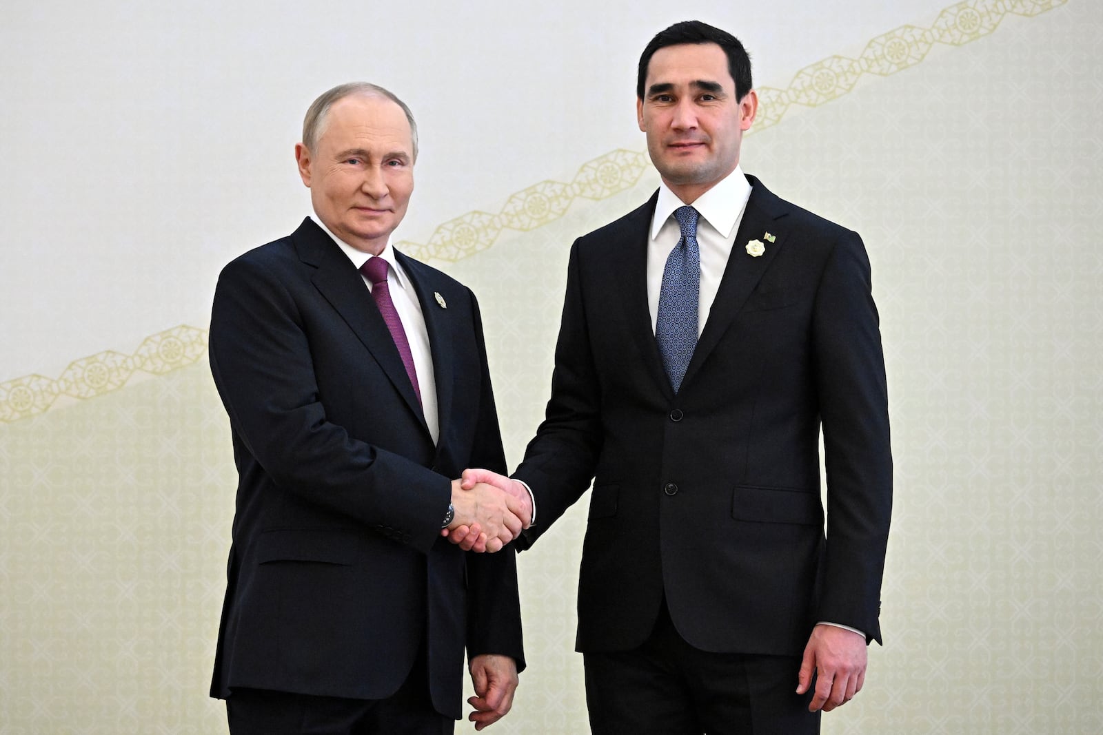 Russian President Vladimir Putin, left, and Turkmenistan's President Serdar Berdimuhamedov shake hands during their meeting on the sidelines of the International Forum "The Interconnection of Times and Civilizations – the basis of peace and development" dedicated to the 300th anniversary of the birth of the outstanding Turkmen poet and thinker Magtymguly Fragi in Ashgabat, Turkmenistan, Friday, Oct. 11, 2024. (Sergei Bobylev, Sputnik, Kremlin Pool Photo via AP)