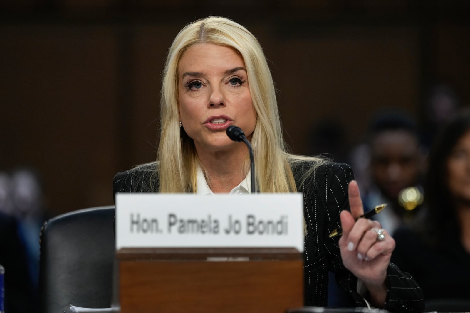 Pam Bondi, President-elect Donald Trump's choice to lead the Justice Department as attorney general, appears before the Senate Judiciary Committee for her confirmation hearing, at the Capitol in Washington, Wednesday, Jan. 15, 2025. (AP Photo/Ben Curtis)