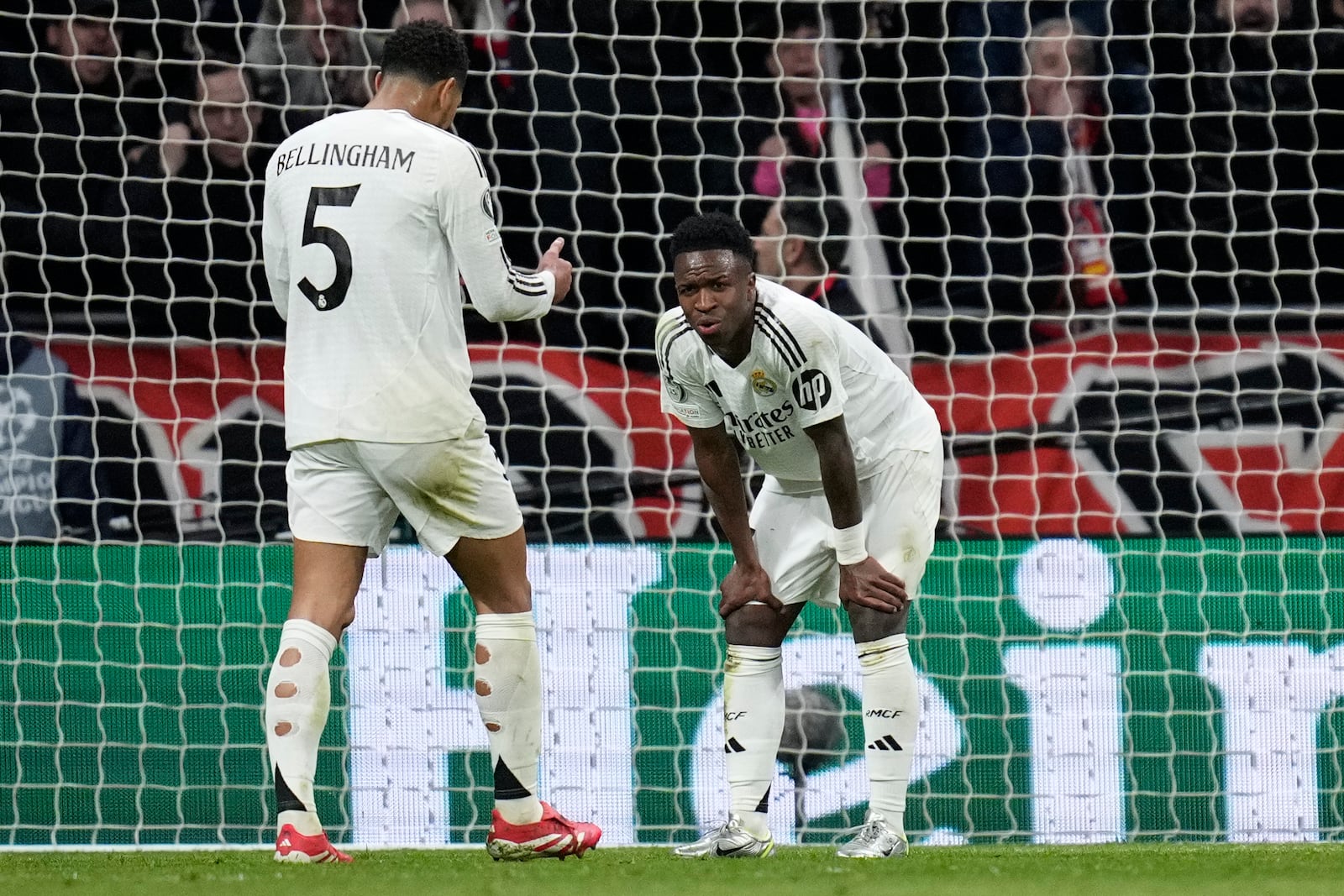 Real Madrid's Vinicius Junior, right, reacts after missing a penalty kick during the Champions League round of 16, second leg, soccer match between Atletico Madrid and Real Madrid at the Metropolitano stadium in Madrid, Spain, Wednesday, March 12, 2025. (AP Photo/Bernat Armangue)