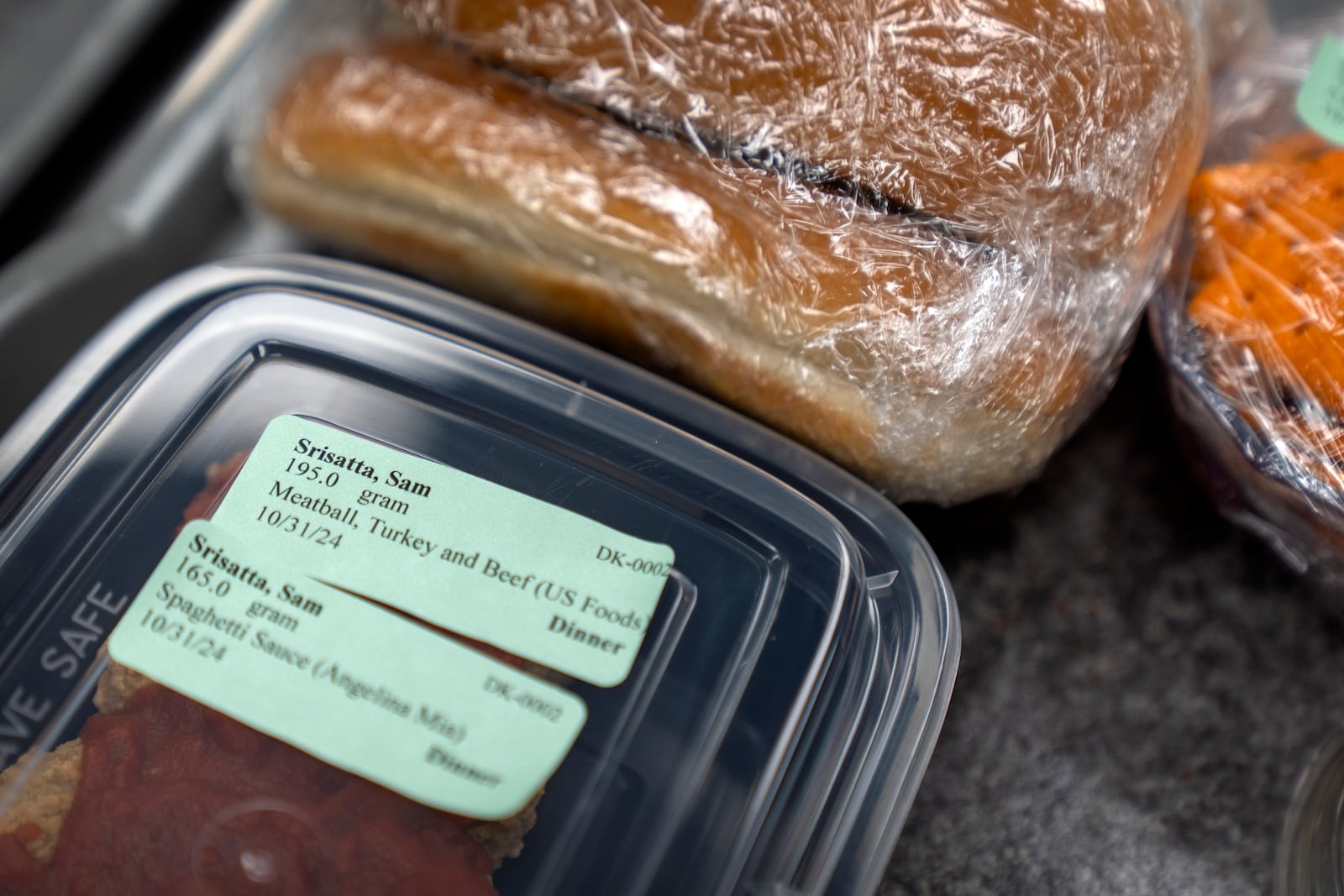 Food labeled and prepared for college student and research subject Sam Srisatta sits on a tray in a kitchen during a study on the health effects of ultraprocessed foods at the National Institutes of Health in Bethesda, Md., on Thursday, Oct. 31, 2024. (AP Photo/Mark Schiefelbein)