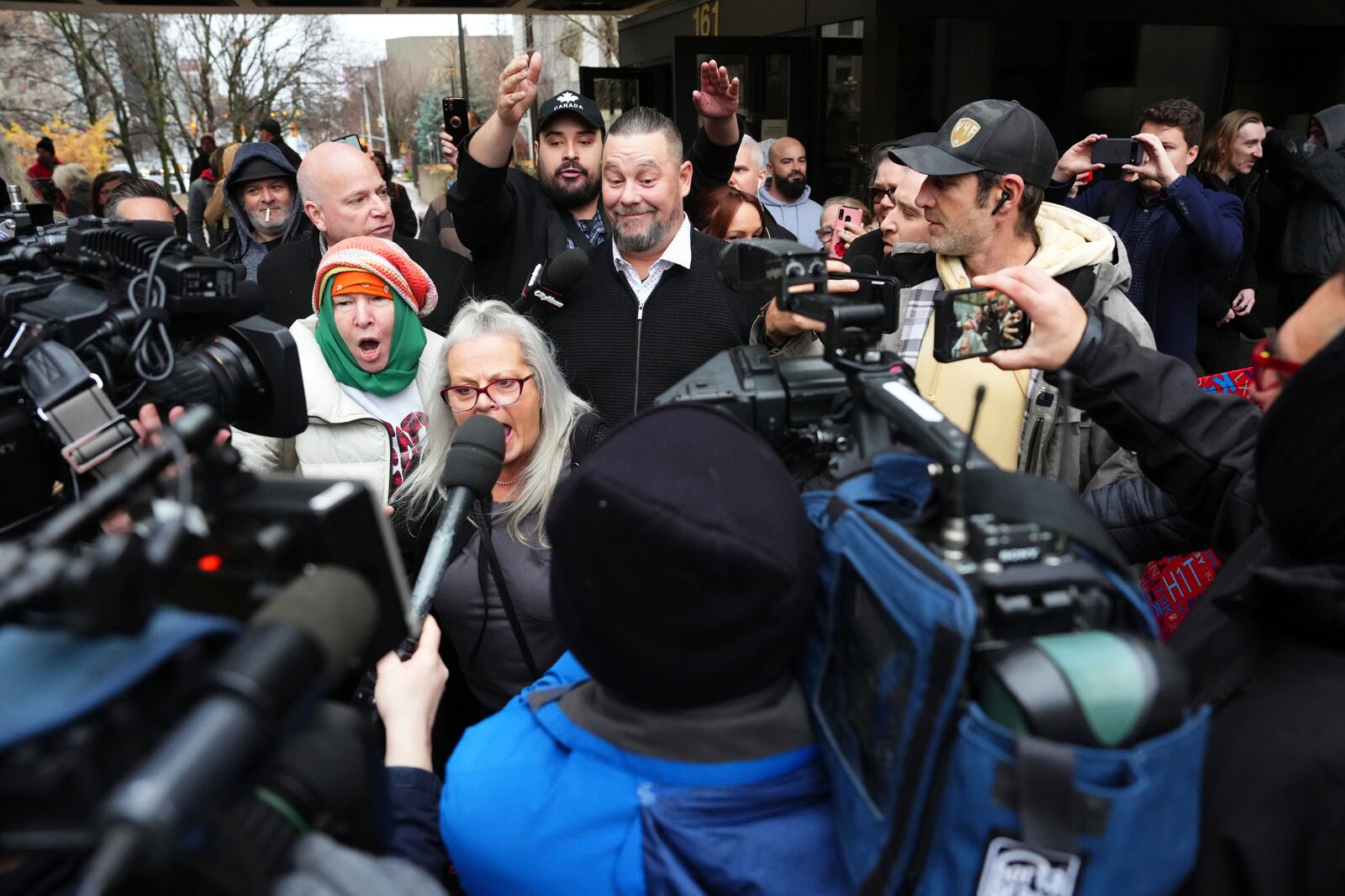 Pat King, a prominent figure in Canada’s trucker protests against COVID-19 restrictions in 2022, is surrounded by supporters as he leaves court in Ottawa, Ontario, Friday, Nov. 22, 2024. (Sean Kilpatrick/The Canadian Press via AP)