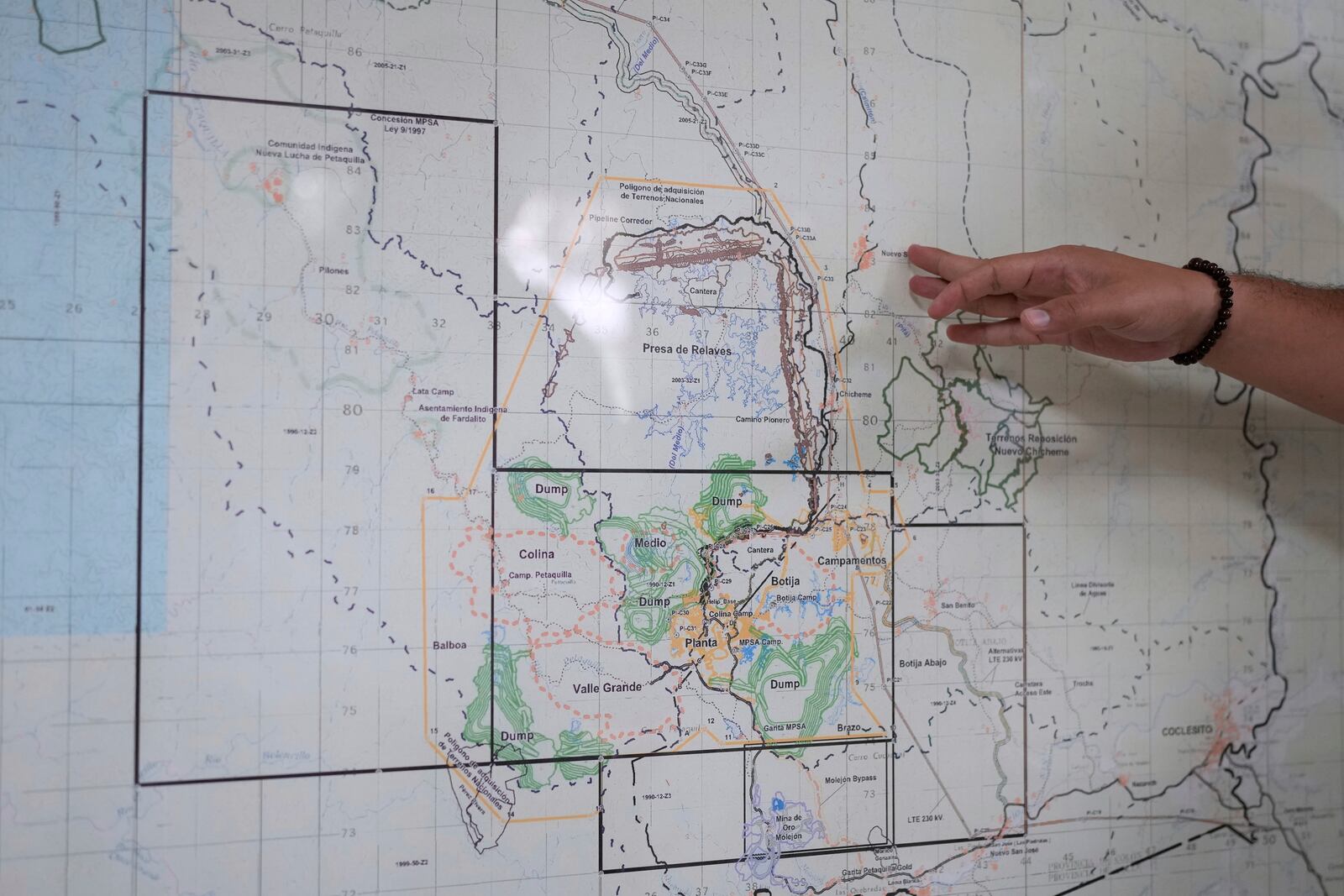 An engineer shows the location of the Cobre Panama copper mine, owned by Canada's First Quantum Minerals, during a press tour of the mine that was closed after Panama's Supreme Court ruled that the government concession was unconstitutional, in Donoso, Panama, Friday, March 21, 2025. (AP Photo/Matias Delacroix)