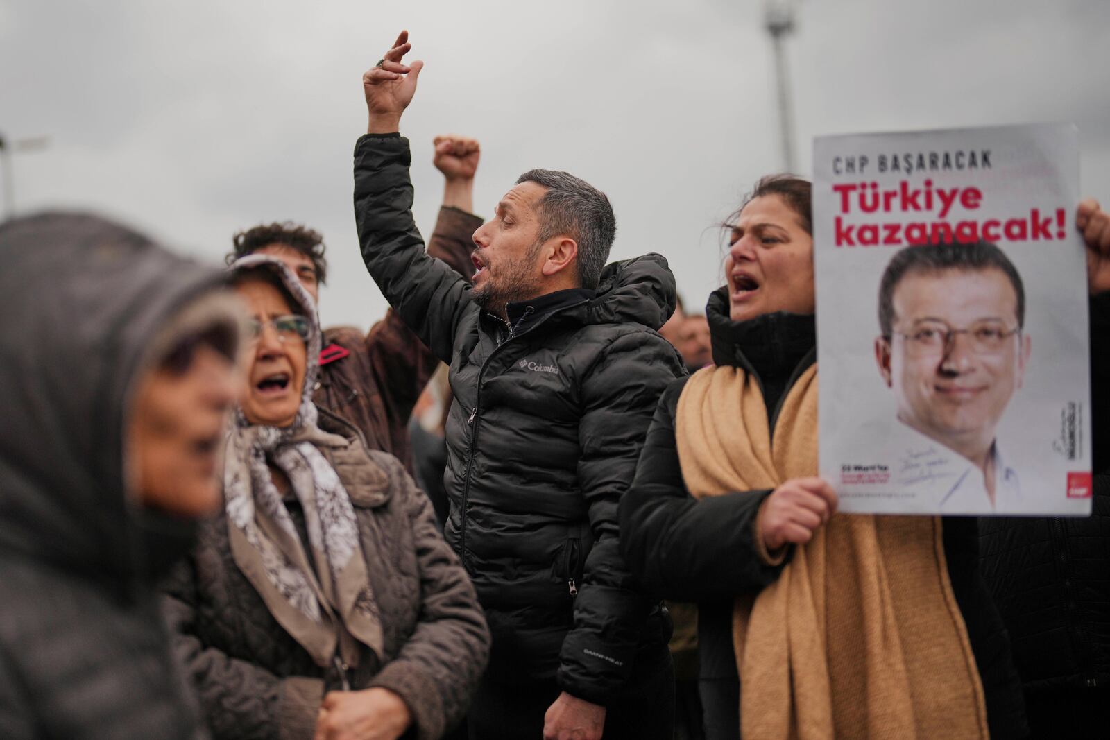 People chant slogans and hold posters of Istanbul Mayor Ekrem Imamoglu as they protest outside the Vatan Security Department, where Imamoglu is expected to be taken following his arrest in Istanbul, Turkey, Wednesday, March 19, 2025. (AP Photo/Francisco Seco)