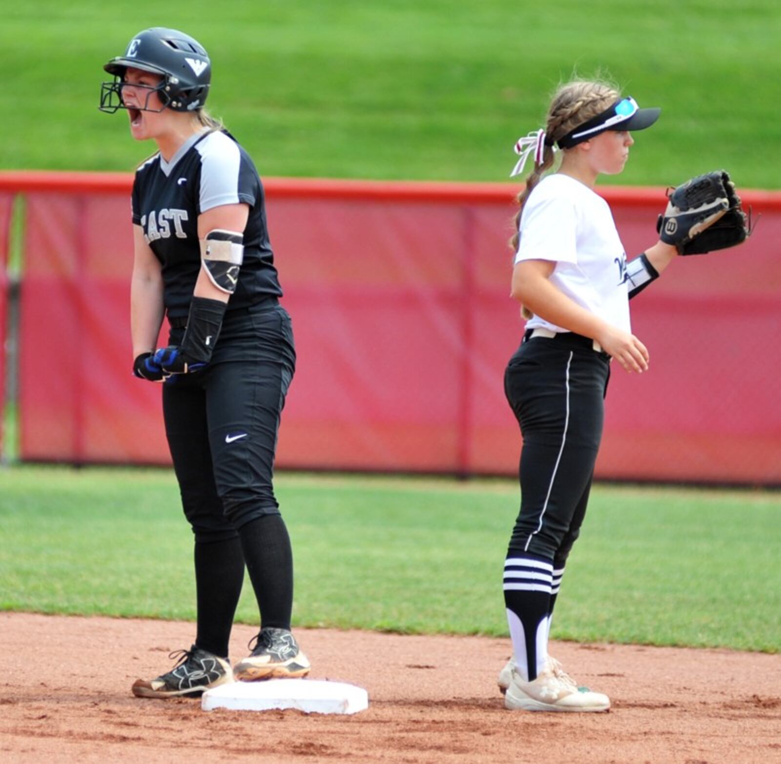 Lakota East’s Cassidy Hudson points to her dugout May 31 after smacking a double against Westerville Central in a Division I state softball semifinal at Firestone Stadium in Akron. That’s the Warhawks’ Emily O’Dee (21) waiting for the ball. East advanced to the state final with a 4-3 win. RICK CASSANO/STAFF