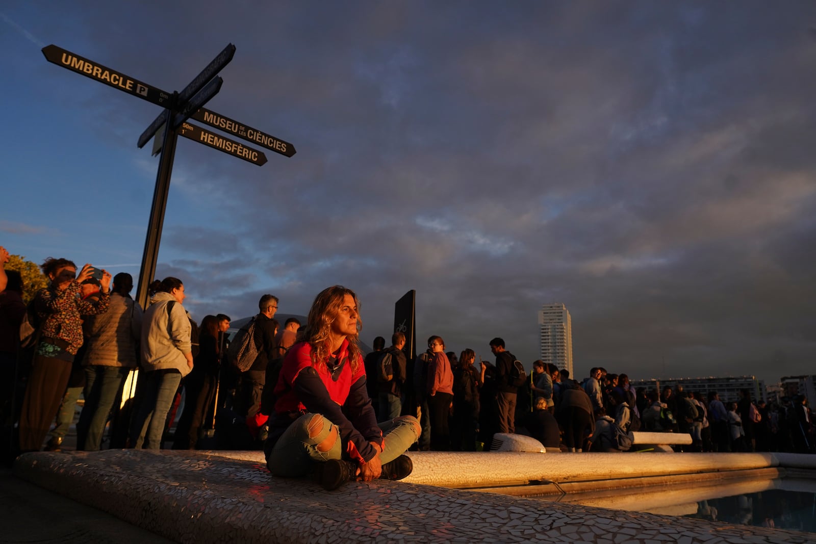 Volunteers wait after thousands showed up to be assigned work schedules to help with the clean up operation after floods in Valencia, Spain, Saturday, Nov. 2, 2024. (AP Photo/Alberto Saiz)