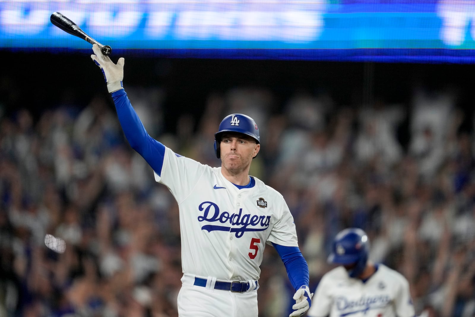 Los Angeles Dodgers' Freddie Freeman celebrates his walk-off grand slam home run against the New York Yankees during the 10th inning in Game 1 of the baseball World Series, Friday, Oct. 25, 2024, in Los Angeles. (AP Photo/Ashley Landis)