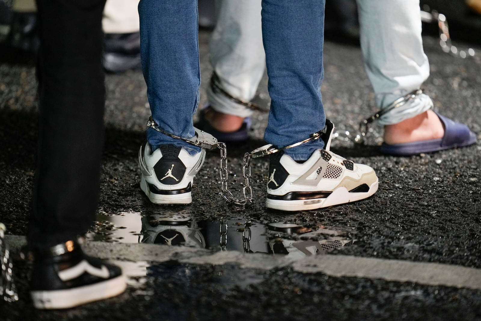 FILE - Shackled Ecuadorian migrants line up to board a plane for deportation from the Albrook airport in Panama City, Aug. 29, 2024. (AP Photo/Matias Delacroix, File)