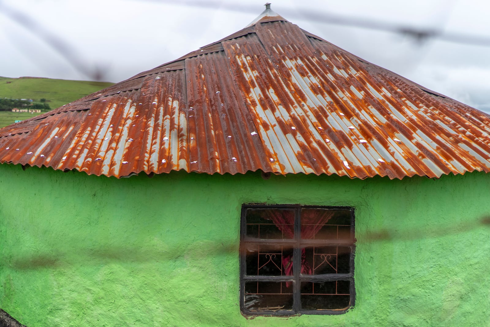 A rusted roof house in Umzimkhulu, KwaZulu Latal, Tuesday, Nov. 11, 2025, where millions of patients in South Africa could be affected by U.S. President Donald Trump's global foreign aid freeze, raising worries about HIV patients defaulting on treatment. (AP Photo/Jerome Delay}