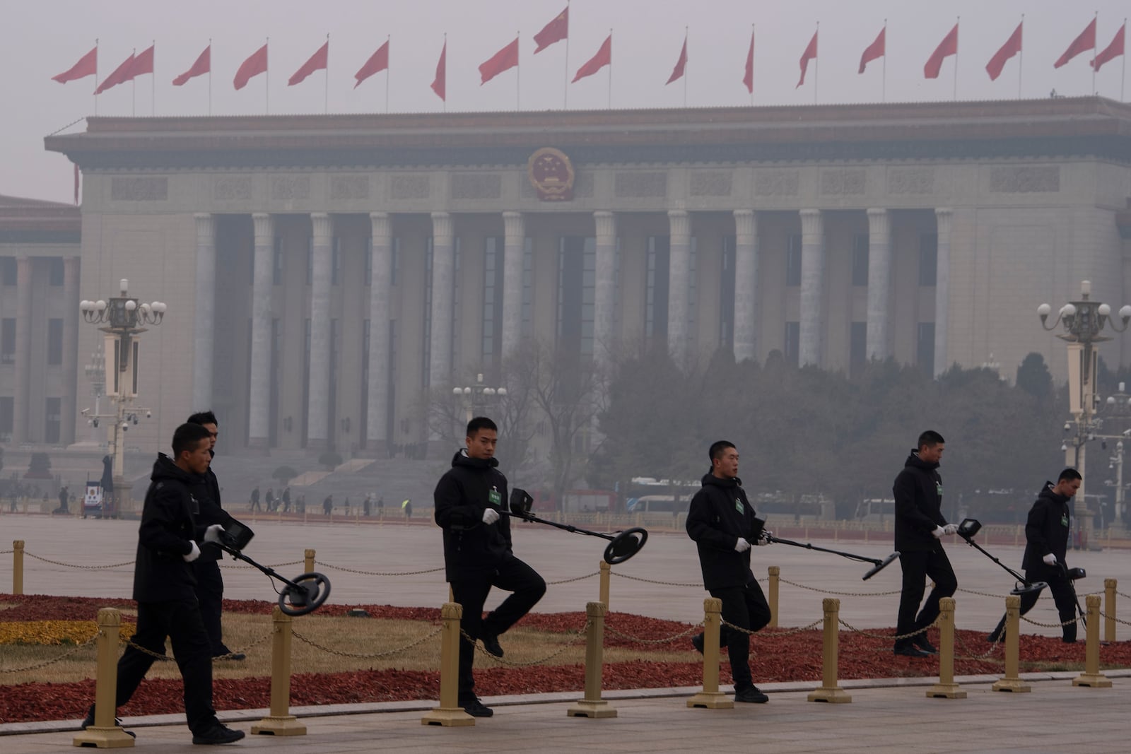 Members of the bomb squad sweep Tiananmen Square before the closing ceremony of the National People's Congress held at the Great Hall of the People in Beijing, Tuesday, March 11, 2025. (AP Photo/Ng Han Guan)