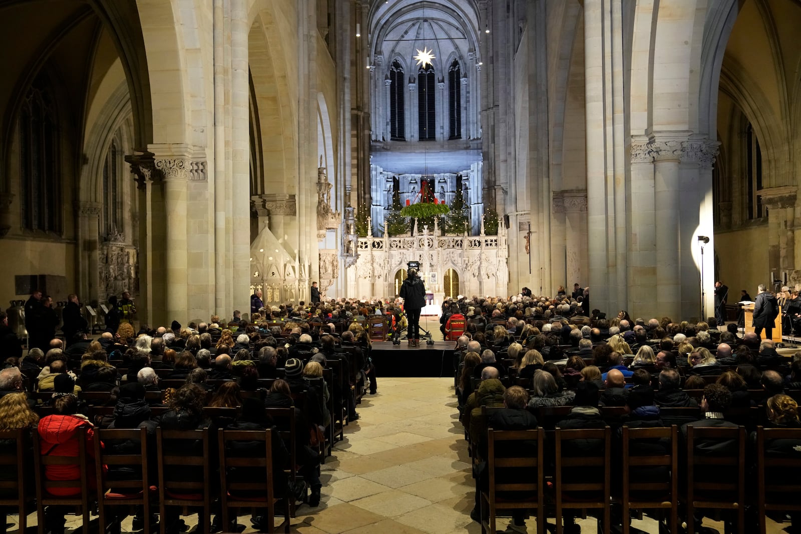 People attend a memorial service for victims of Friday's Christmas Market attack, where a car drove into a crowd, in Magdeburg, Germany, Saturday, Dec. 21, 2024. (AP Photo/Ebrahim Noroozi)