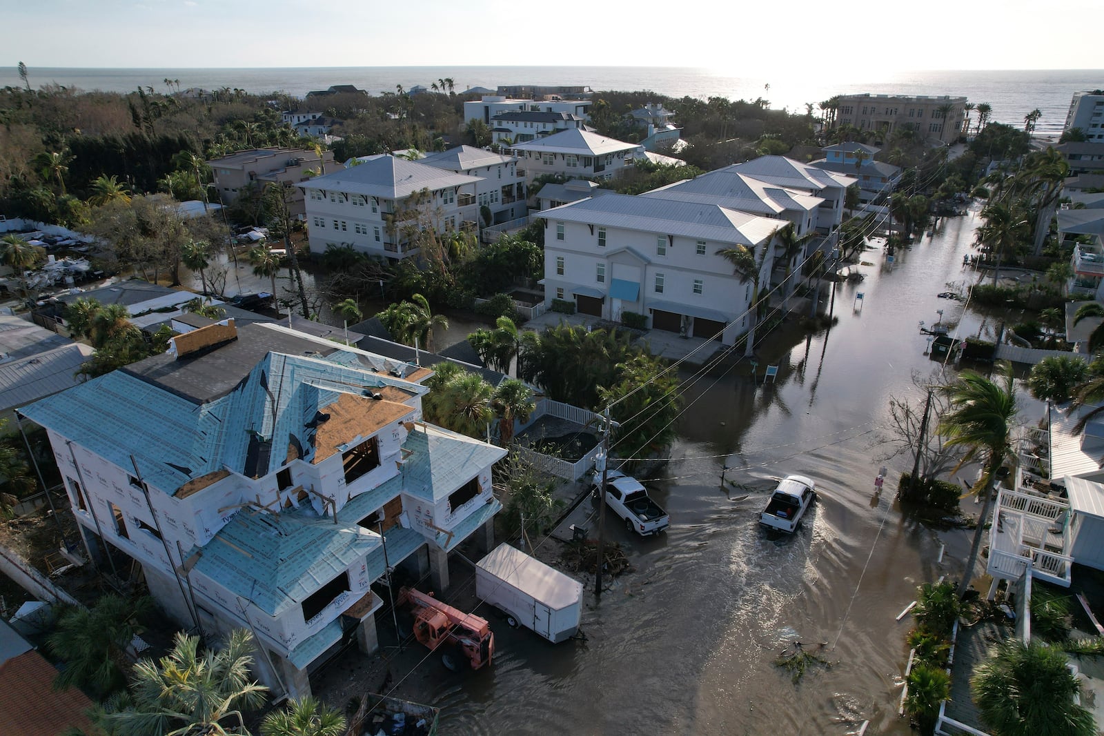 FILE - A truck drives down a flooded street in Siesta Key, Fla., following the passage of Hurricane Milton, Oct. 10, 2024. (AP Photo/Rebecca Blackwell, File)