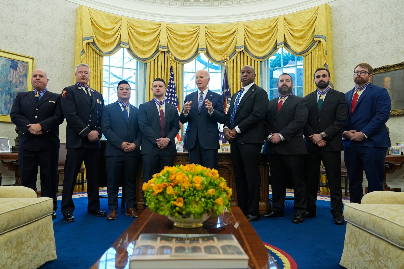 President Joe Biden, center, poses for a photo with Medal of Valor honorees in the Oval Office of the White House in Washington, Friday, Jan. 3, 2025. Honorees are, from left, Lt. John Vanderstar of the New York City Fire Department, Firefighter Brendan Gaffney of the New York City Fire Department, Sgt. Tu Tran, of the Lincoln, Neb. Police Department, Det. Michael Collazo, of the Nashville, Tenn. Police Department, Chief John Drake, receiving on behalf of Officer Rex Engelbert, of the Nashville, Tenn. Police Department, Sgt. Jeffrey Mathes, of the Nashville, Tenn. Police Department, Det. Zachary Plese, of the Nashville, Tenn. Police Department, and Det. Ryan Cagle, of the Nashville, Tenn. Police Department. (AP Photo/Susan Walsh)