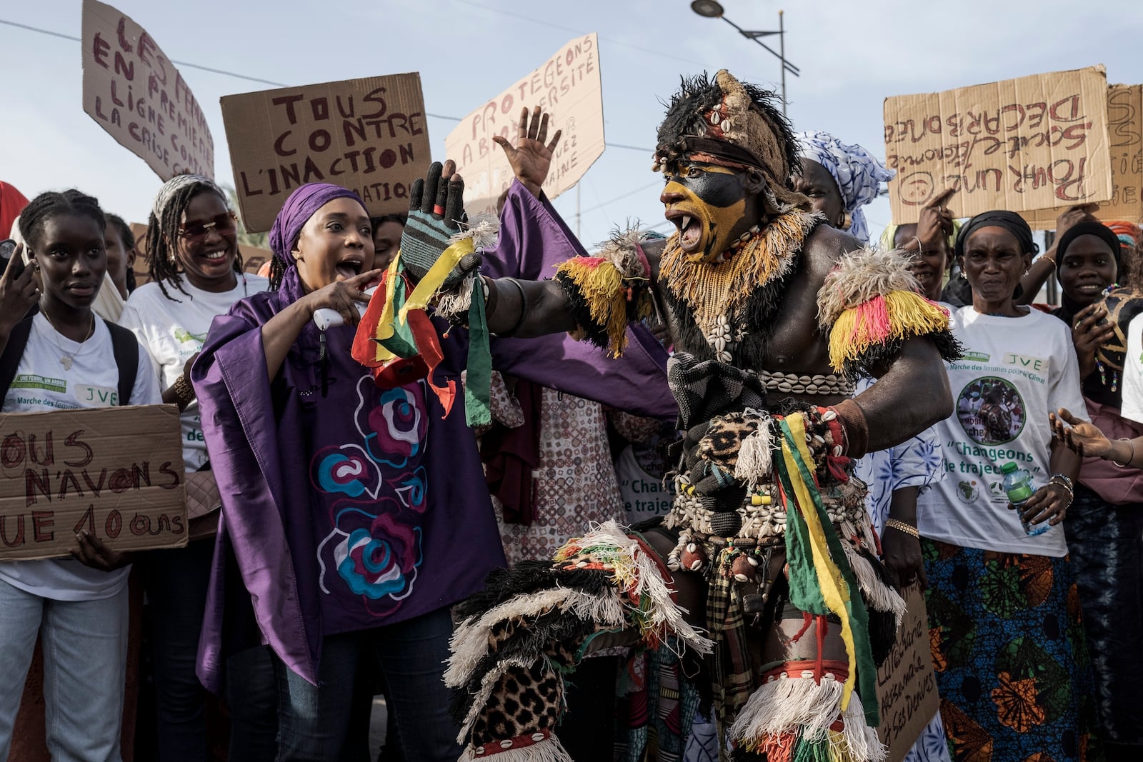 About 50 Senegalese women, joined by a performer dressed as a "faux lion", march through Dakar's Medina neighborhood in Senegal, during the fourth Women's March for Climate on Nov. 2, 2024. (AP Photo/Annika Hammerschlag)