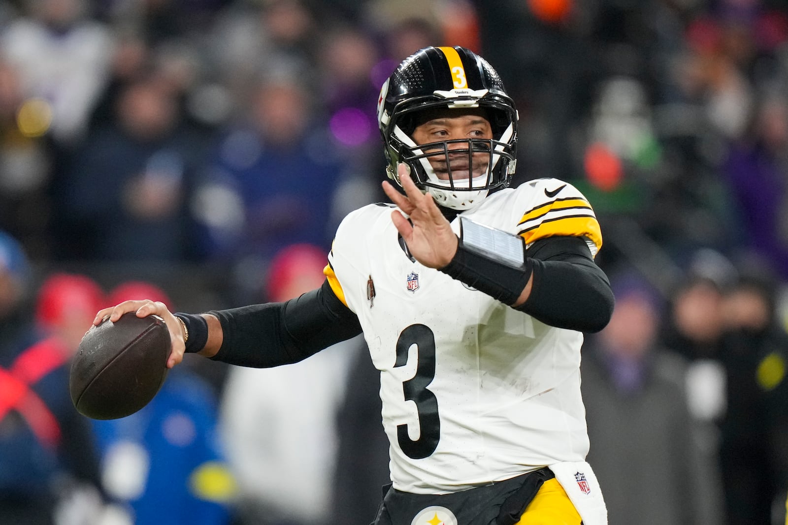 Pittsburgh Steelers quarterback Russell Wilson throws a pass against the Baltimore Ravens during the first half of an NFL wild-card playoff football game, Saturday, Jan. 11, 2025, in Baltimore. (AP Photo/Stephanie Scarbrough)