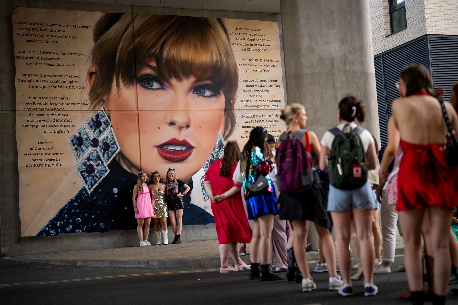 FILE - Taylor Swift fans pose in front of a mural before attending Swift's concert on June 21, 2024 in London. (Photo by Scott A Garfitt/Invision/AP, File)