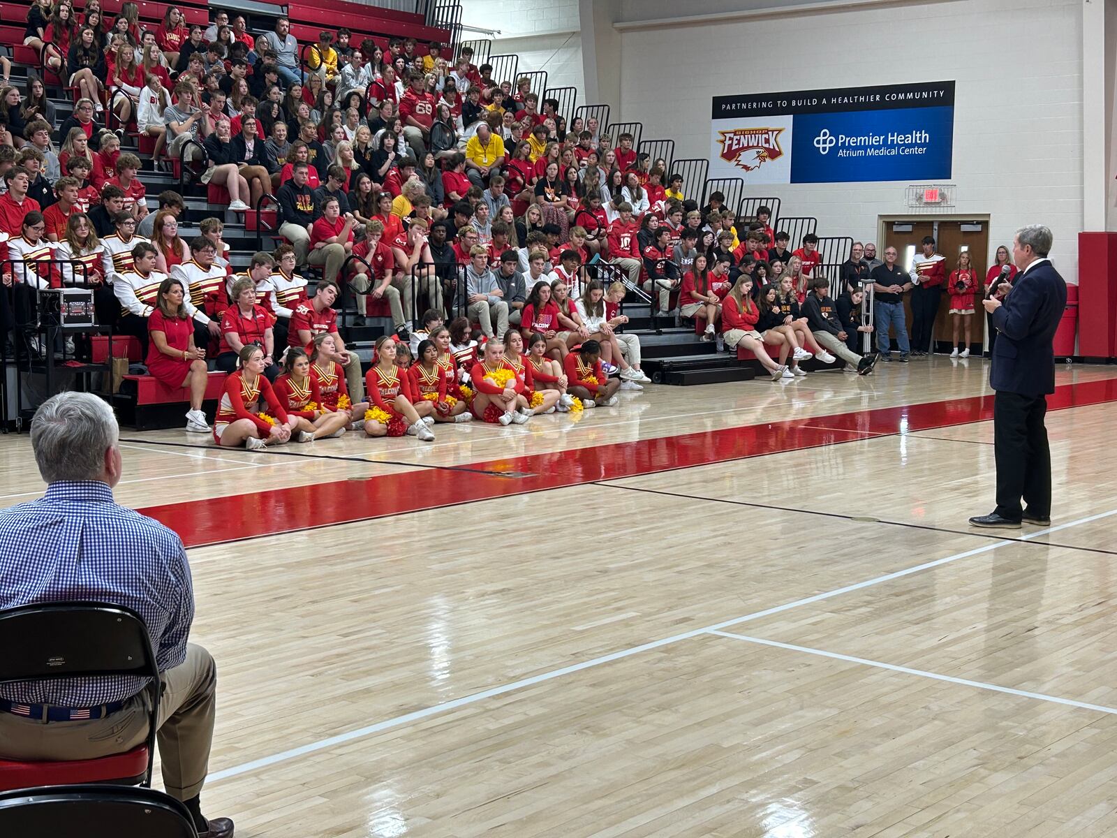 Jim Akers, a 1974 Fenwick High School graduate, addresses the Fenwick student body Friday morning during as assembly that honored his family. RICK McCRABB/CONTRIBUTING REPORTER