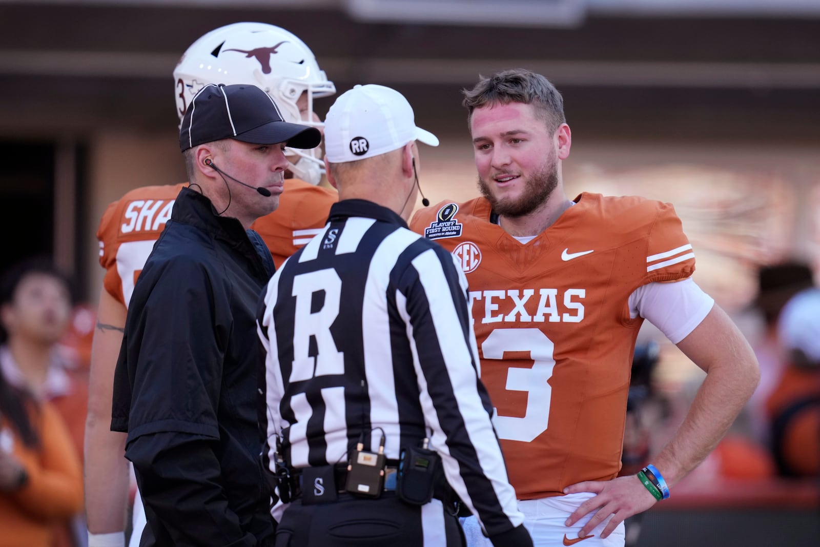 Texas quarterback Quinn Ewers (3) talks with officials before a first round game against Clemson in the NCAA College Football Playoff, Saturday, Dec. 21, 2024, in Austin, Texas. (AP Photo/Eric Gay)