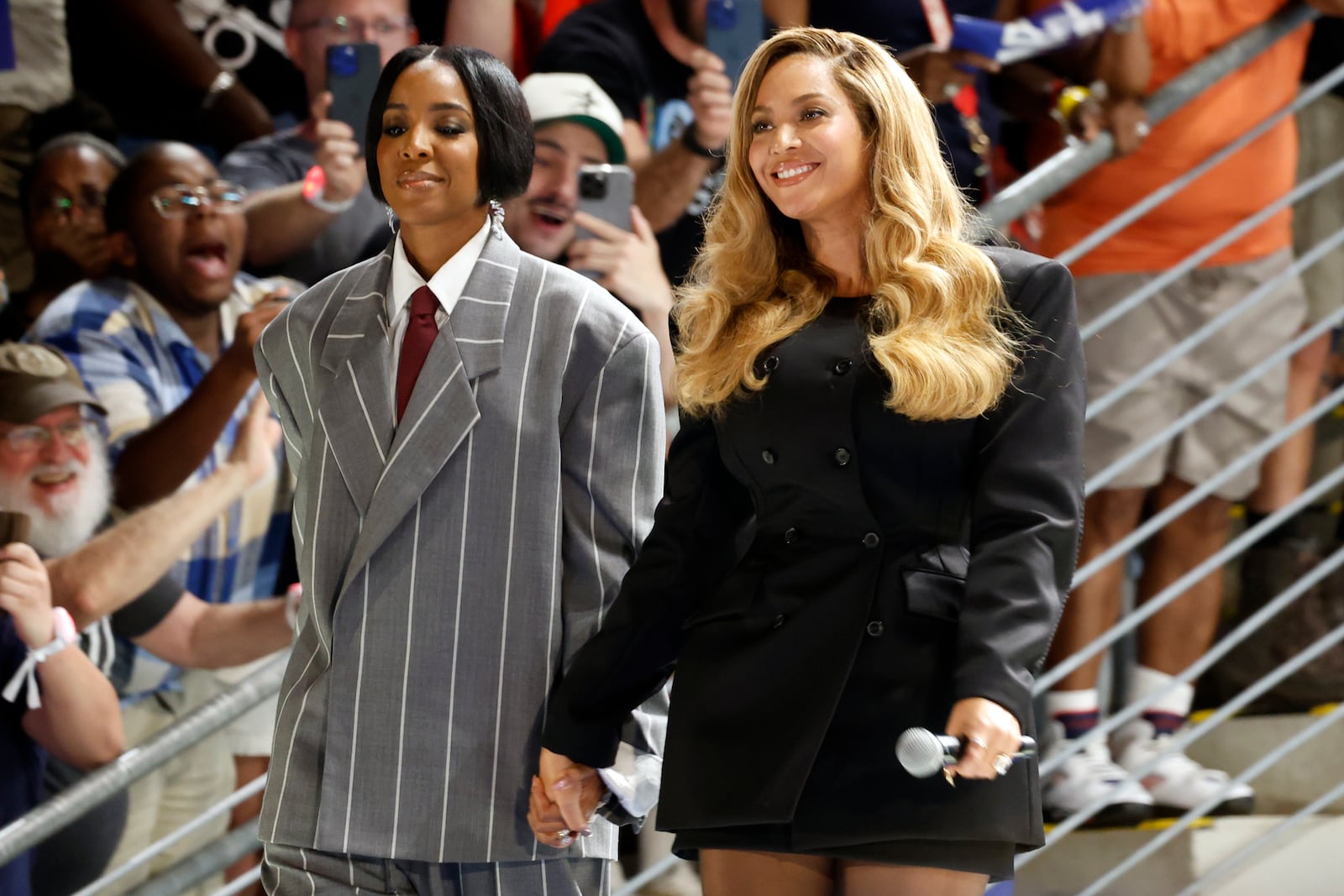 Musical artists Beyonce, right, and Kelly Rowland, left, on stage at a campaign event for Democratic presidential nominee Vice President Kamala Harris, Friday, Oct. 25, 2024, in Houston. (AP Photo/Annie Mulligan)