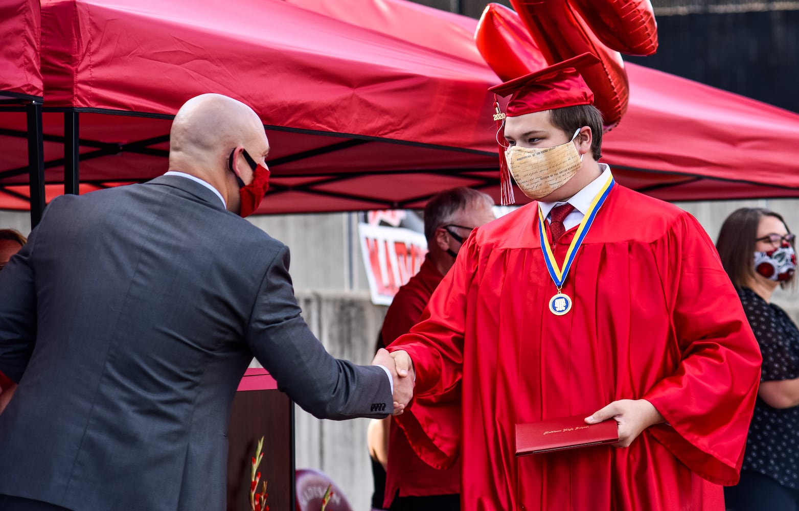 Madison High School drive-thru graduation ceremony at Land of Illusion