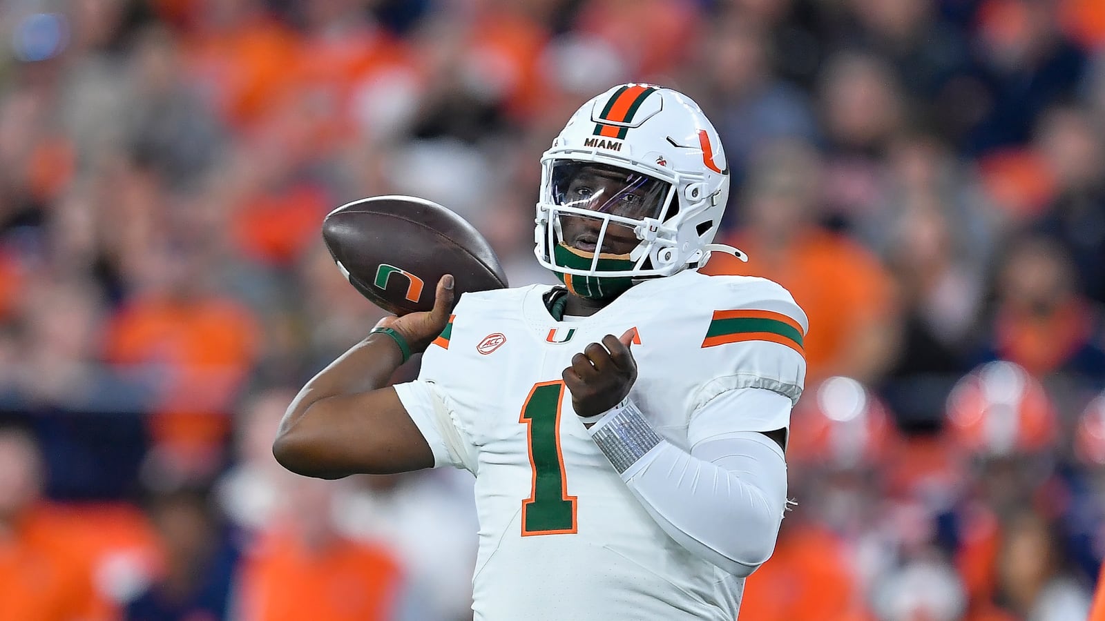 FILE - Miami quarterback Cam Ward throws during the first half of an NCAA college football game against Syracuse on, Nov. 30, 2024 in Syracuse, N.Y. (AP Photo/Adrian Kraus, File)