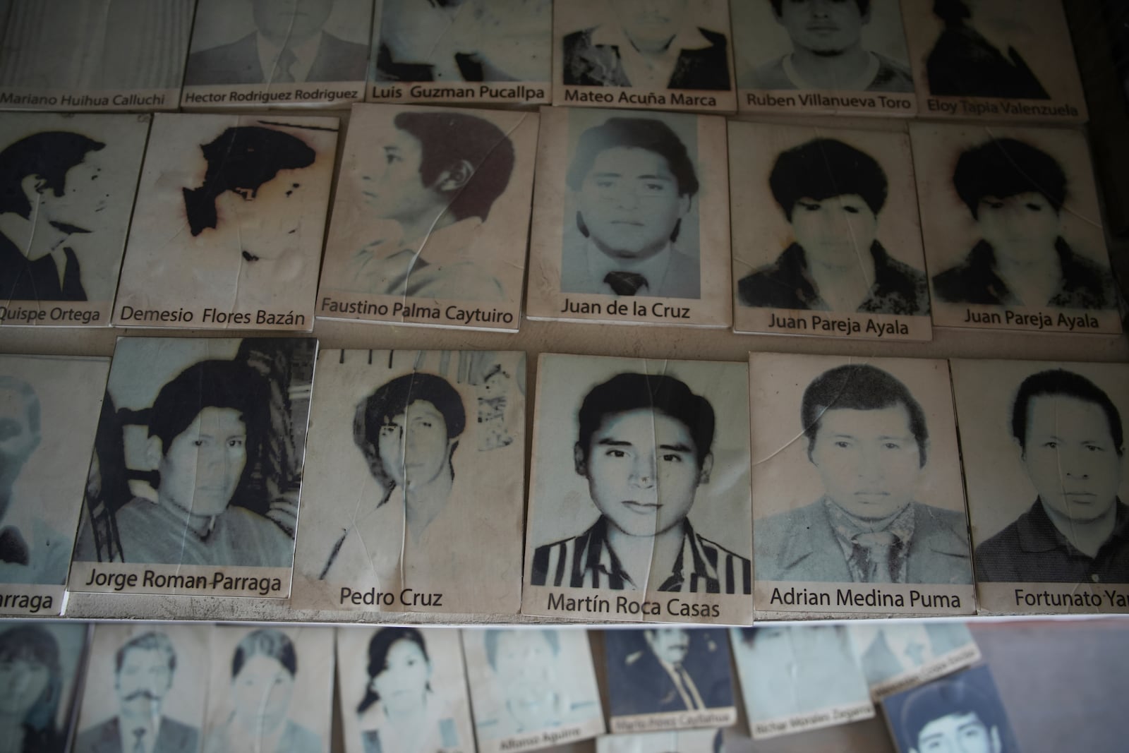 Photos of people who disappeared during Peru's internal armed conflict (1980-2000) lie on display at the House of Memory museum in Lima, Peru, Sunday, Oct. 20, 2024. (AP Photo/Guadalupe Pardo)