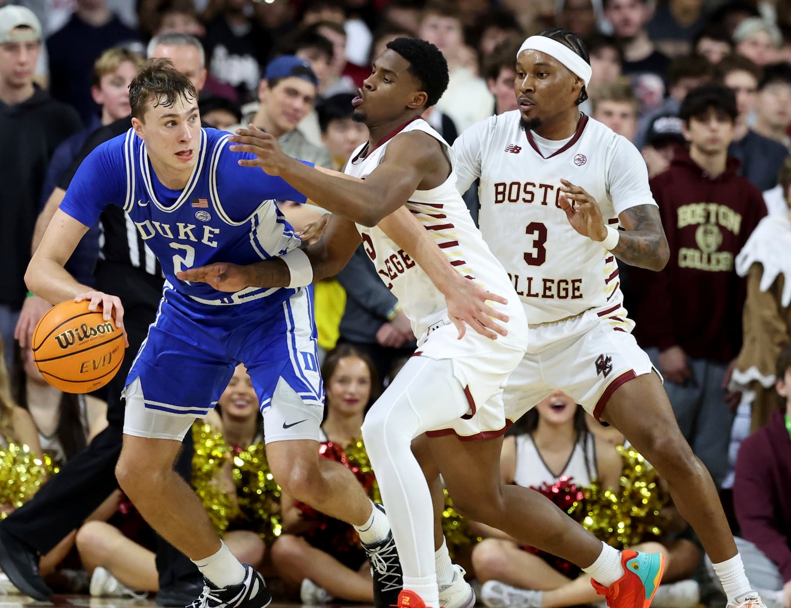 Duke guard Cooper Flagg (2) defends the ball from Boston College guards Fred Payne, center, and Roger McFarlane (3) during the second half of an NCAA college basketball game Saturday, Jan. 18, 2025, in Boston. (AP Photo/Mark Stockwell)