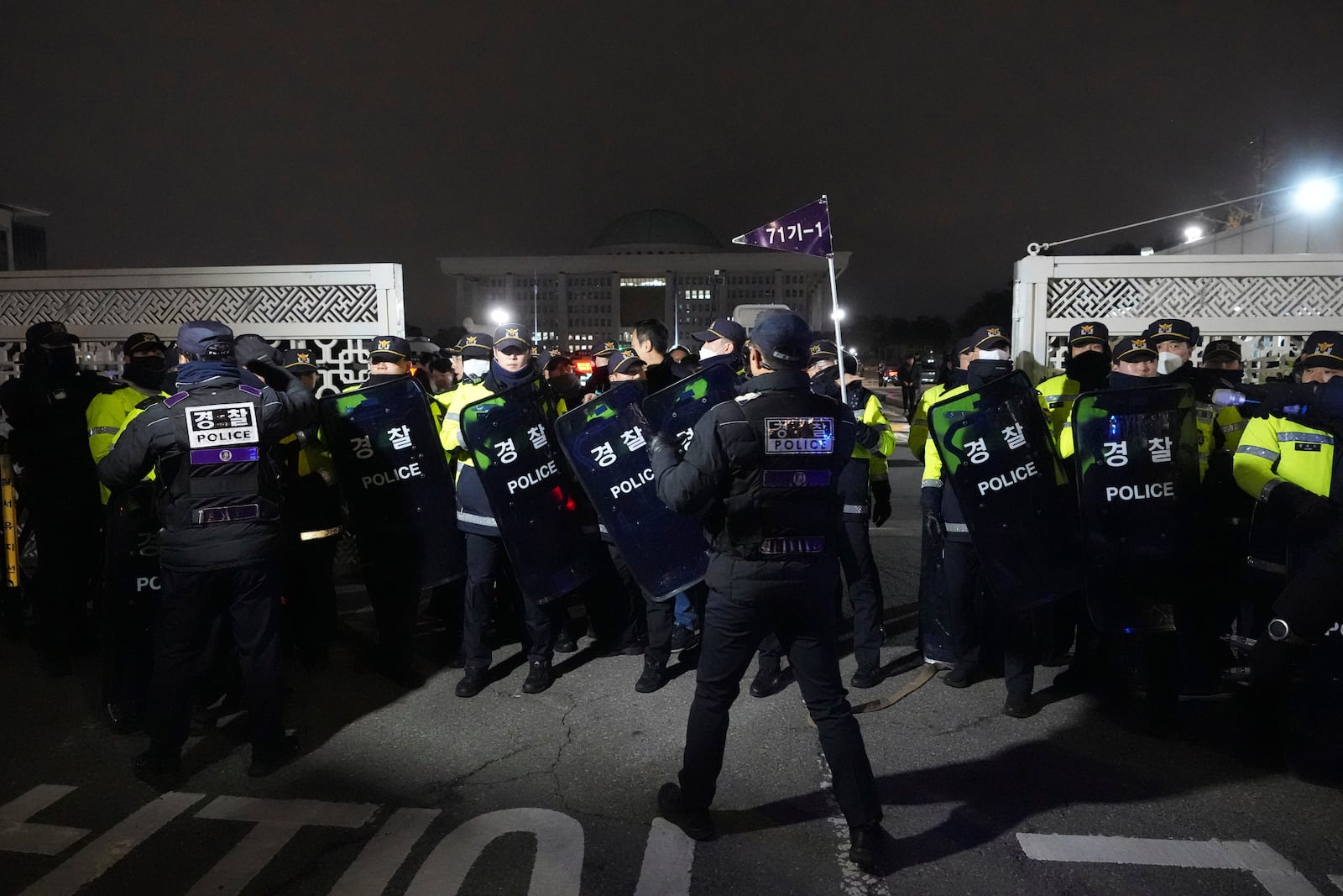 Police officers stand guard in front of the National Assembly in Seoul, South Korea, Tuesday, Dec. 3, 2024. (AP Photo/Lee Jin-man)