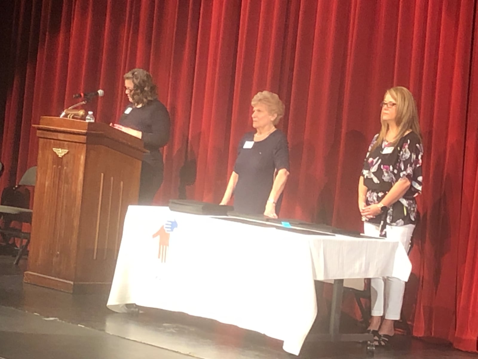 Sarah Nathan, left, executive director of the Middletown Community Foundation, addresses the crowd at Dave Finkelman Auditorium as Carole Schul, center, volunteer chair of the scholarship committee, and Sarah Watson, program officer, prepare to present the students their certificates. RICK McCRABB/STAFF