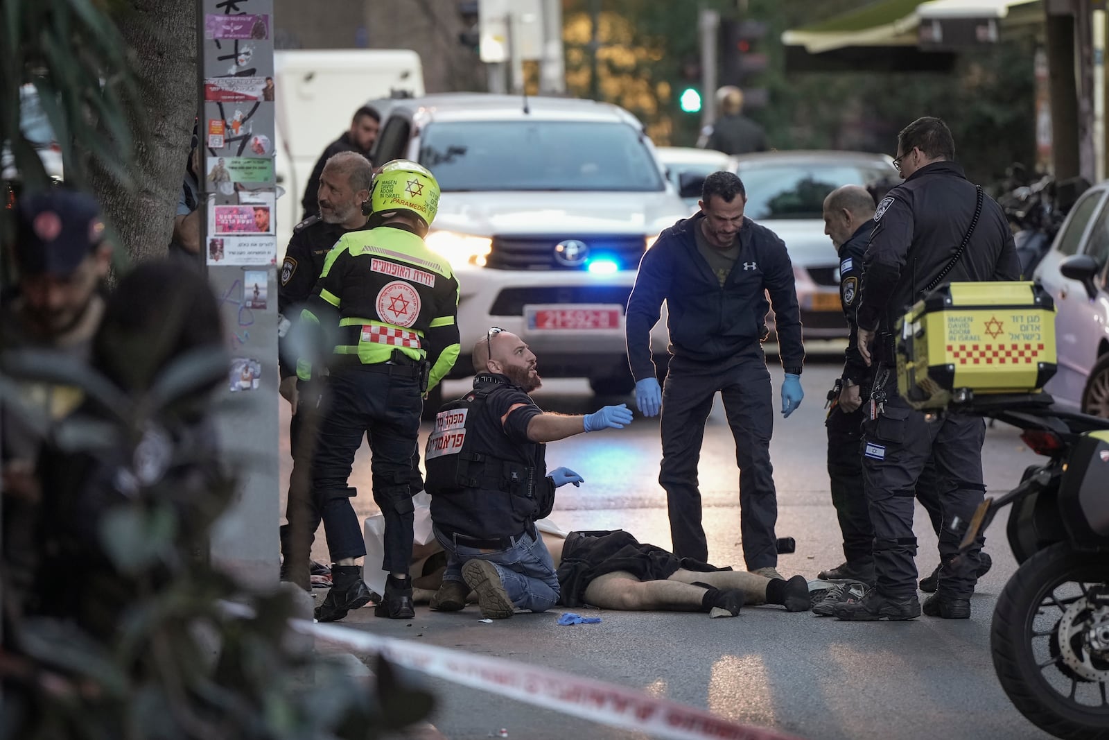 The body of a man who attacked pedestrians with a knife is examined by Israeli police after he was shot during the stabbing incident in Tel Aviv, Israel, Saturday Jan. 18, 2025.(AP Photo/Oded Balilty)