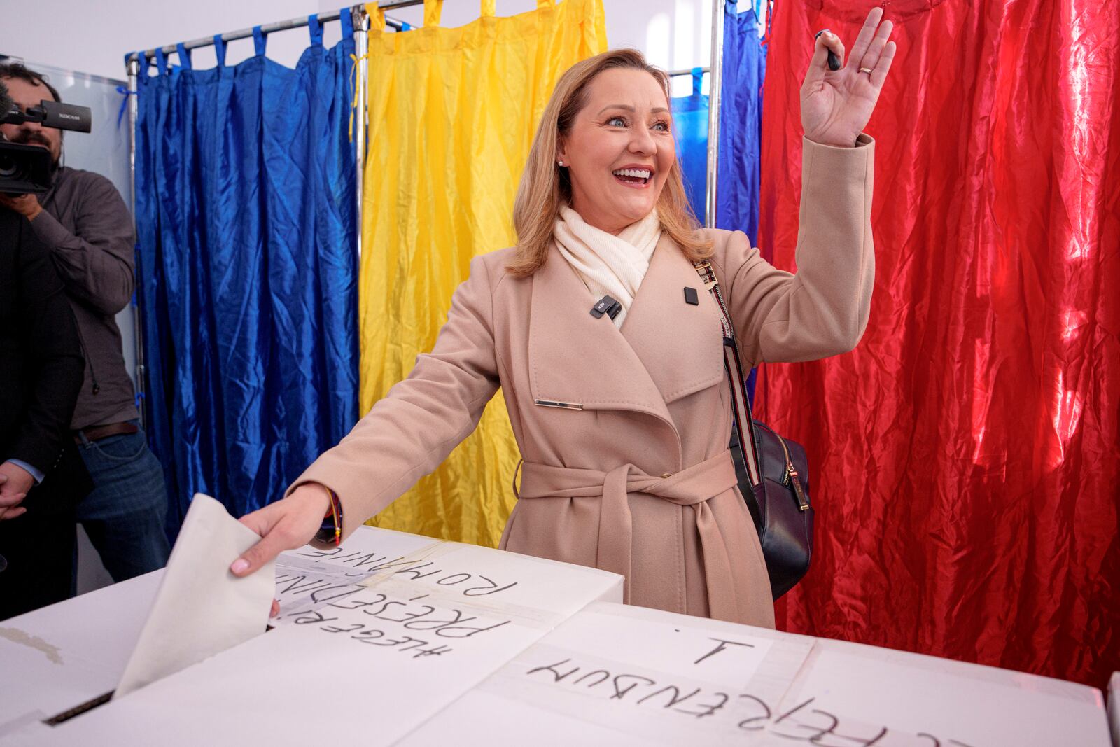 Elena Lasconi, the Save Romania Union (USR) party candidate for president, gestures as she casts her vote in the country's presidential elections, in Bucharest, Romania, Sunday, Nov. 24, 2024. (AP Photo/Andreea Alexandru)