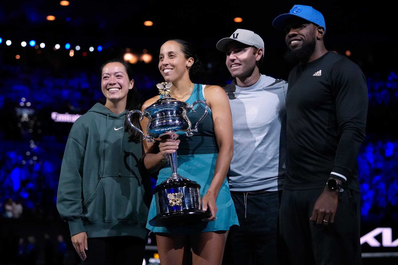 Madison Keys, center, of the U.S. holds the Daphne Akhurst Memorial Cup with her coaching team after defeating Aryna Sabalenka of Belarus in the women's singles final at the Australian Open tennis championship in Melbourne, Australia, Saturday, Jan. 25, 2025. (AP Photo/Asanka Brendon Ratnayake)