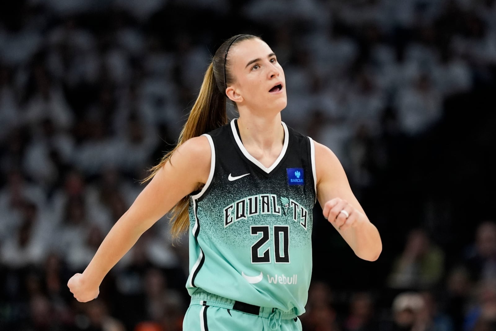 New York Liberty guard Sabrina Ionescu (20) reacts after missing a basket against the Minnesota Lynx during the first half of Game 4 of a WNBA basketball final playoff series, Friday, Oct. 18, 2024, in Minneapolis. (AP Photo/Abbie Parr)