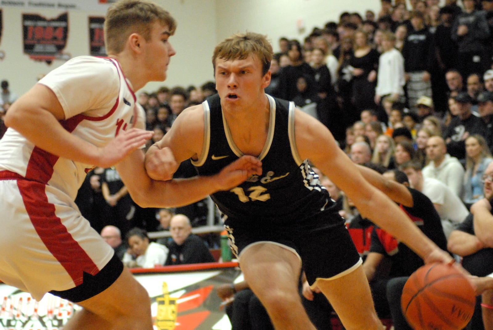 Lakota East's Derek Jackson drives the lane against Lakota West's LJ Green on Friday night. Chris Vogt/CONTRIBUTED