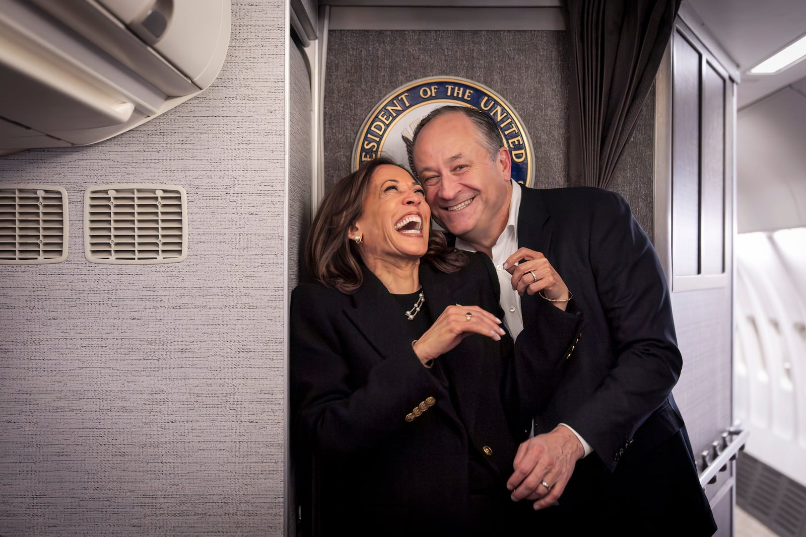 Democratic presidential nominee Vice President Kamala Harris, left, shares a laugh with second gentleman Doug Emhoff, after reuniting in Pittsburgh, Monday, Nov. 4, 2024, aboard Air Force Two, just before taking off from Pittsburgh for her final campaign rally in Philadelphia. (AP Photo/Jacquelyn Martin, Pool)